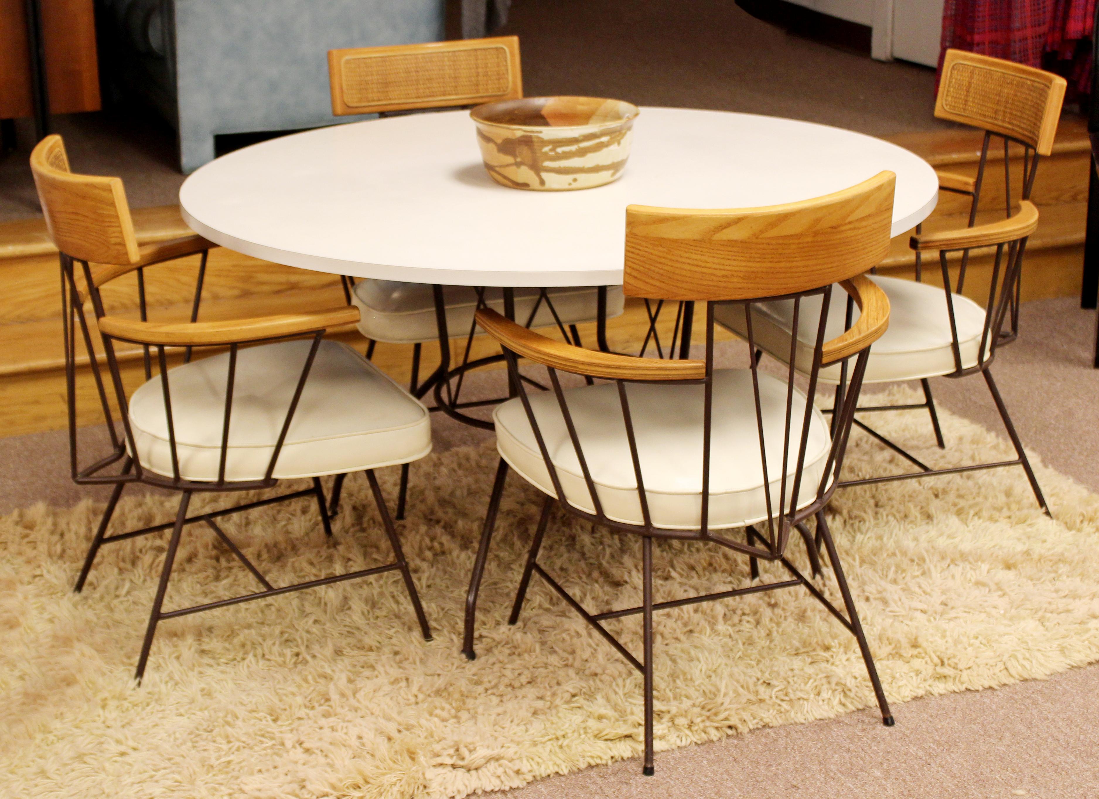 For your consideration is a stupefyingly beautiful dinette set, including table and pair of chairs, by Richard McCarthy for Selrite, circa 1960s. The table is made of wrought iron and white laminate and the chairs are wrought iron with rush