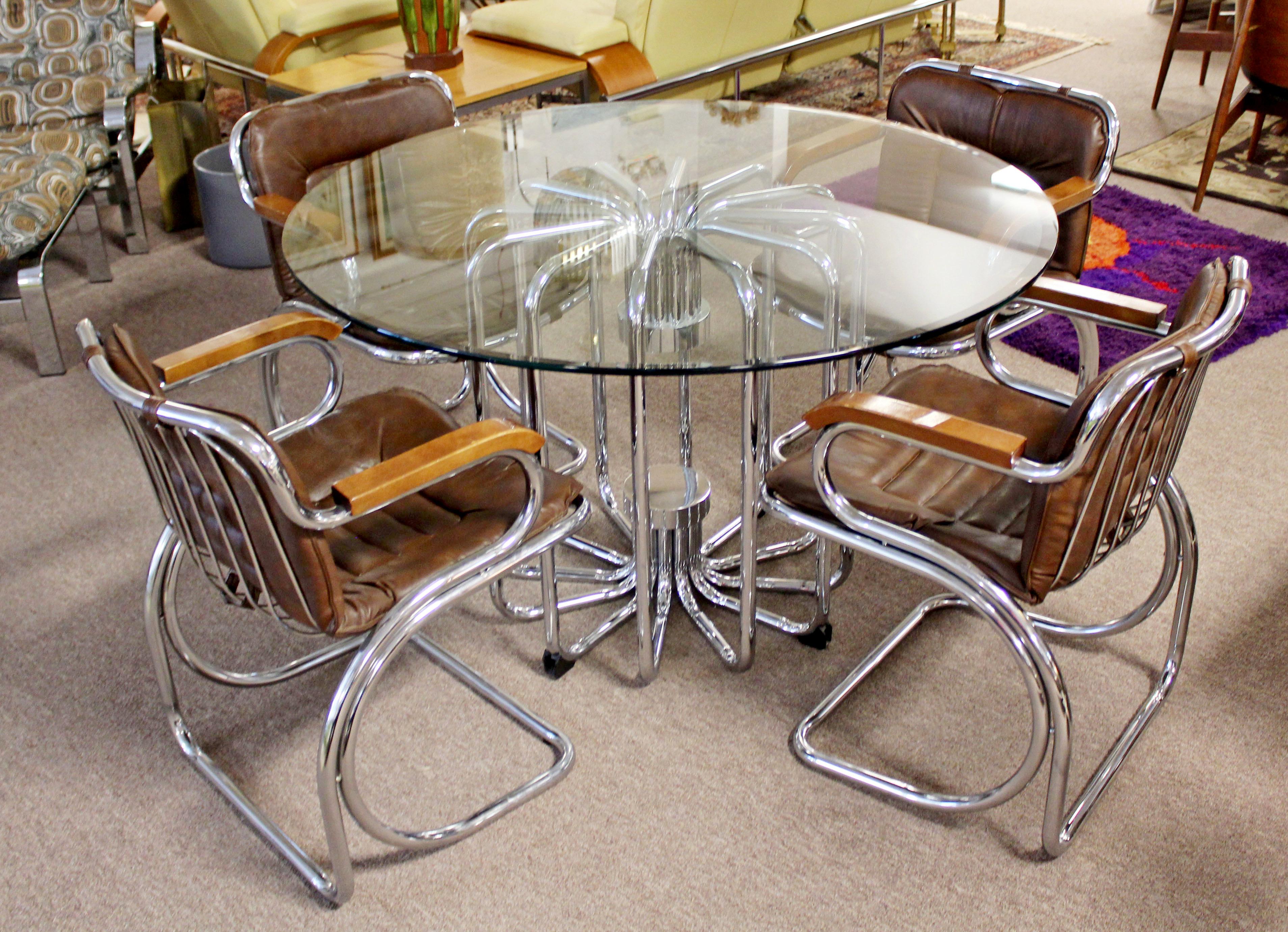 For your consideration is an Italian round dinette table with a unique tubular chrome base and a set of four brown leather chairs with chrome bases by Gastone Rinaldi, circa 1970s. In excellent condition with a few minor imperfections on the