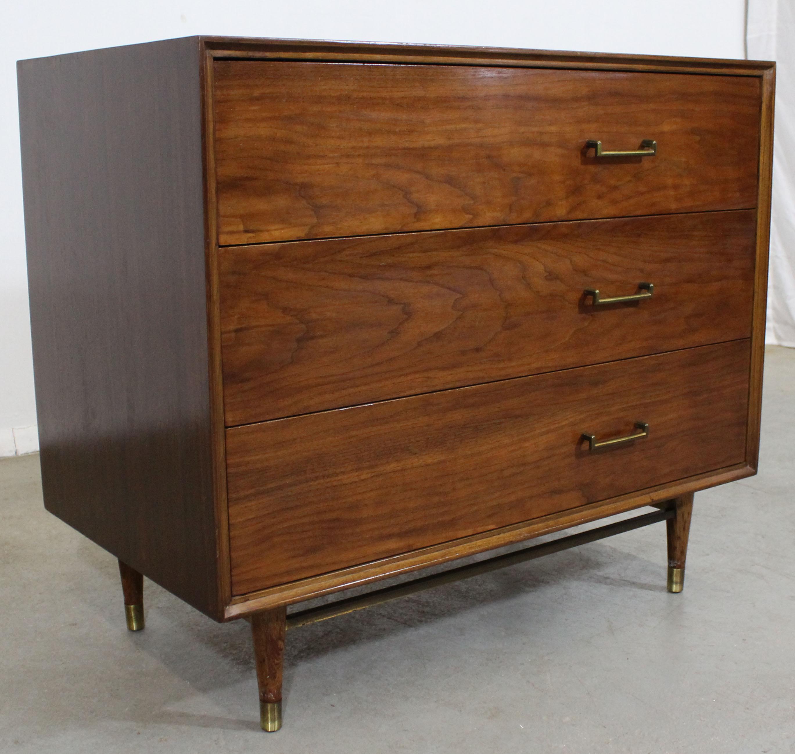 Offered is a perfect example of American Mid-Century Modern furniture; a walnut and brass bachelor chest, believed to be designed by Mark J. Furst & Robert Fellner for Furnette. Features three drawers with pulls skewed to the right. It is in good