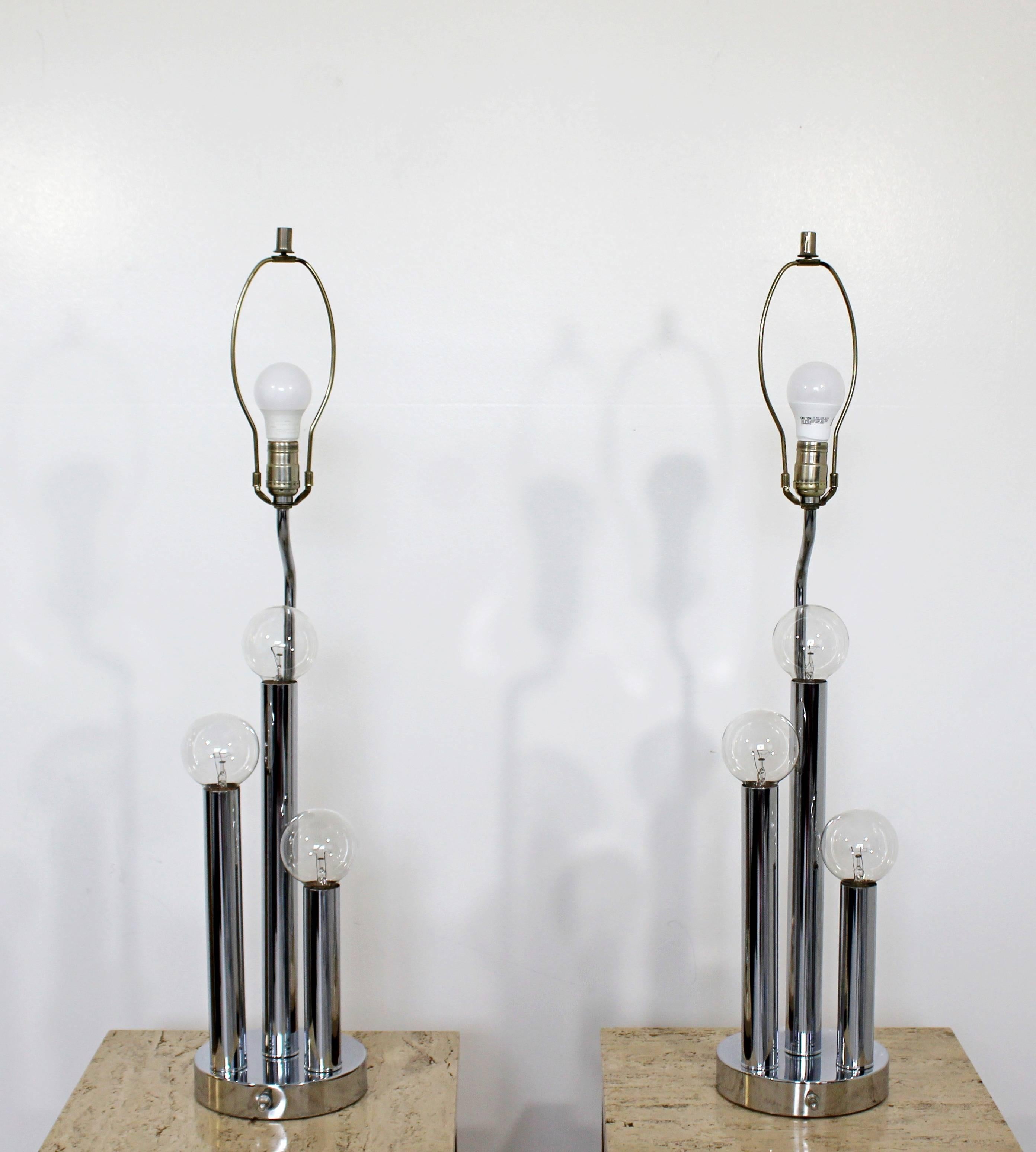 For your consideration is a fabulous pair of chrome table lamps, each with four bulbs, by Robert Sonneman, circa 1970s. In excellent condition. The dimensions of each lamp are 7.5