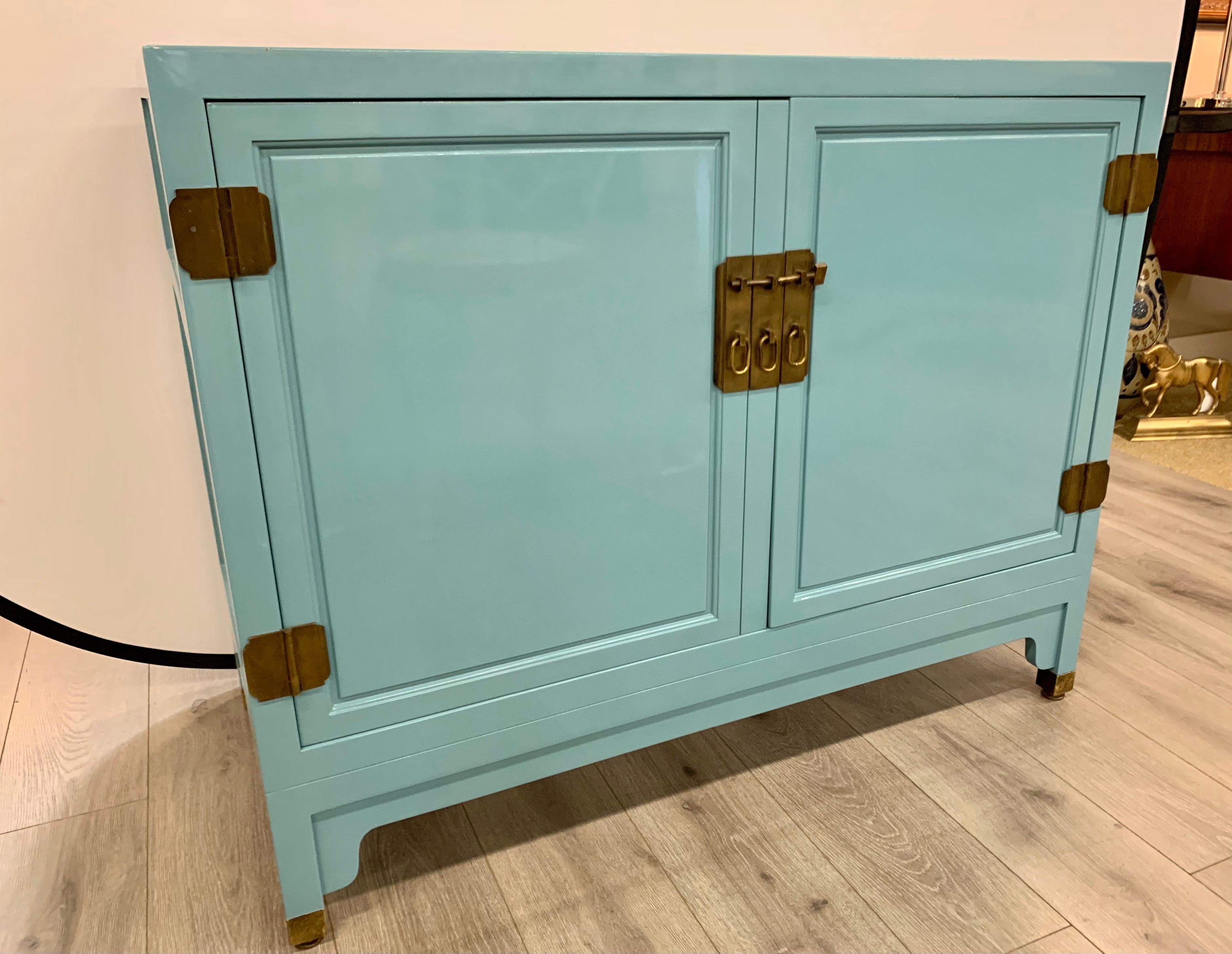 Newly lacquered in a robins egg blue tone is this mid century cabinet. Great scale and better lines. One small paint chip at top - see pics. Otherwise mint condition. Now, more than ever, home is where the heart is.