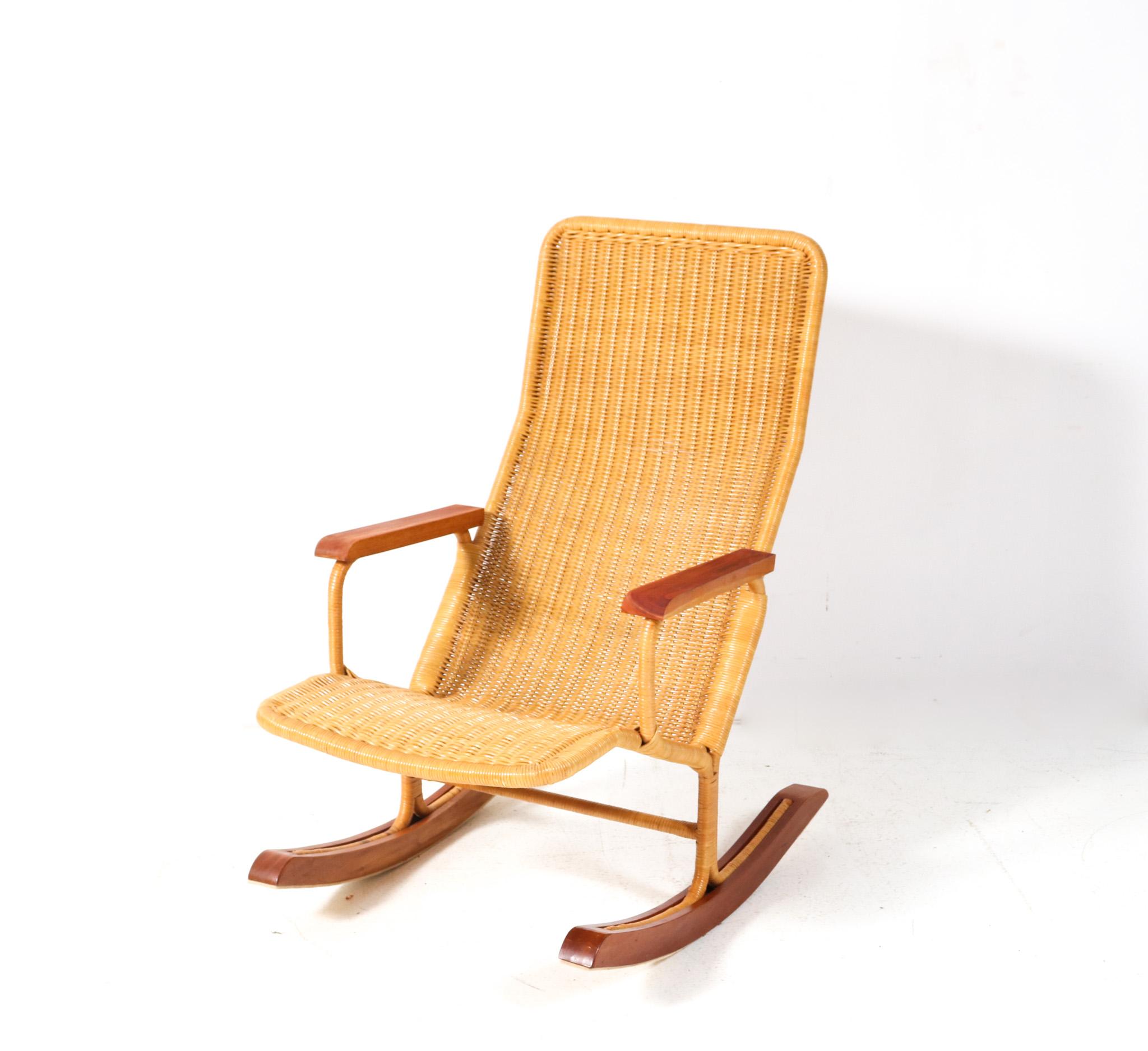 Magnificent and ultra rare Mid-Century Modern rocking chair.
Design by Dirk van Sliedregt for Gebroeders Jonkers Noordwolde.
Striking Dutch design from the 1960s.
Original rattan frame with original solid teak armrests and solid teak feet.
This