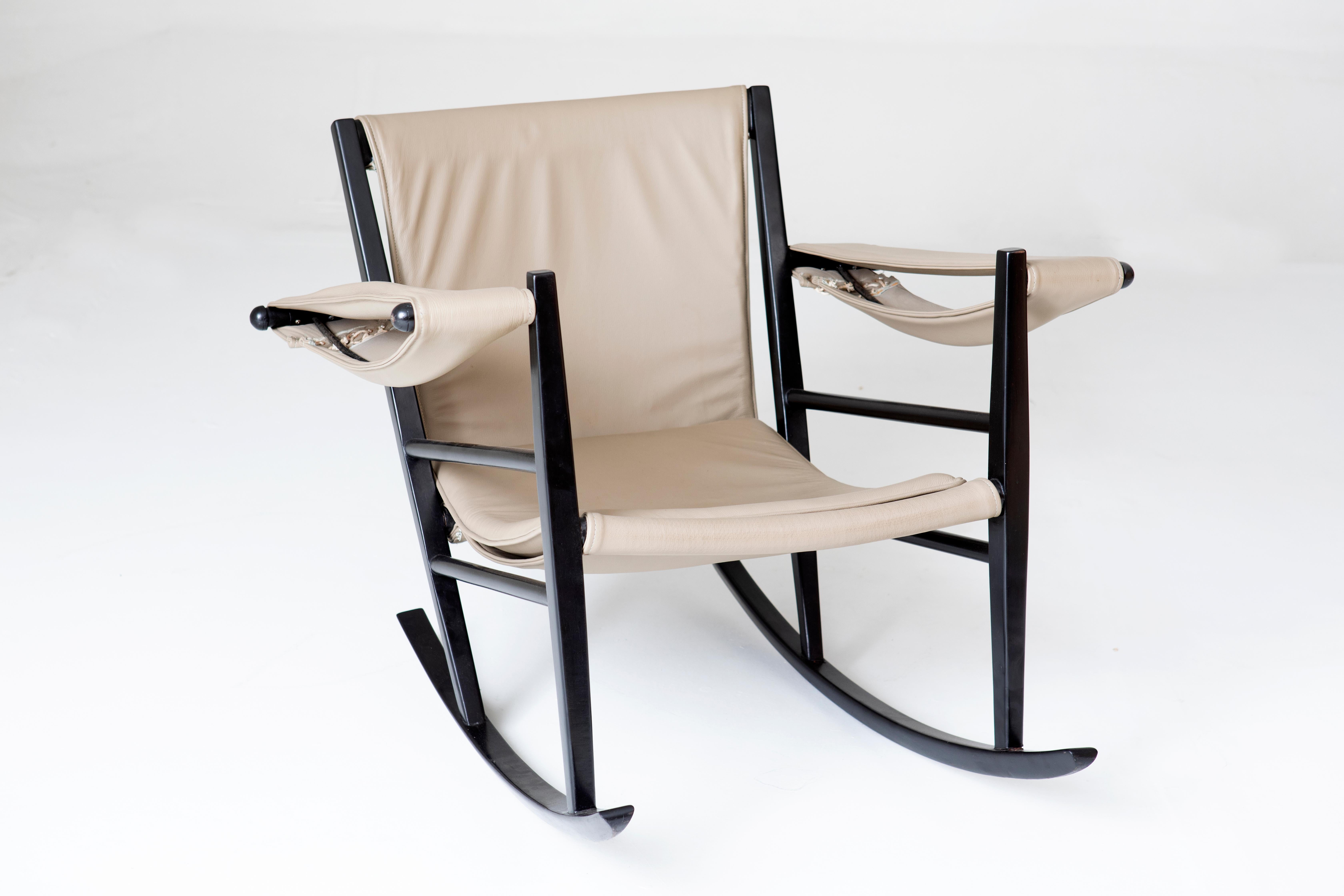 Mid-Century Modern Rocking Chair by Joaquim Tenreiro, 1950s

The structure of the chair is made of wood, while the seat and backrest are made of beige fabric, offering a sophisticated contrast. The armrests are also made from the same fabric and are