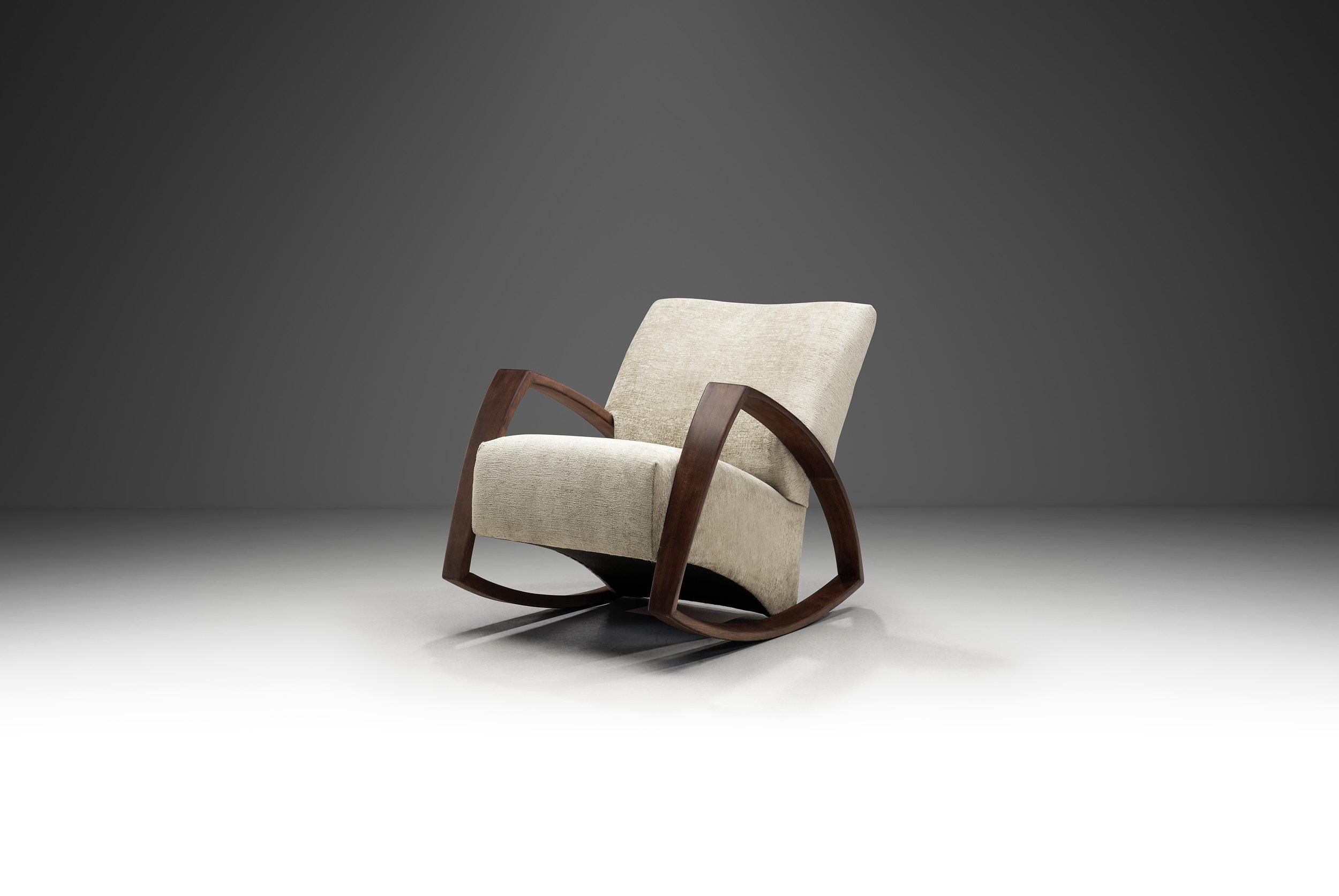 Mid-century modern furniture is characterised by its clean lines, gentle curves, and organic shapes. In this piece, the elegant character of this popular design movement meets the timeless allure of a rocker (or rocking chair), soothing and cosy.