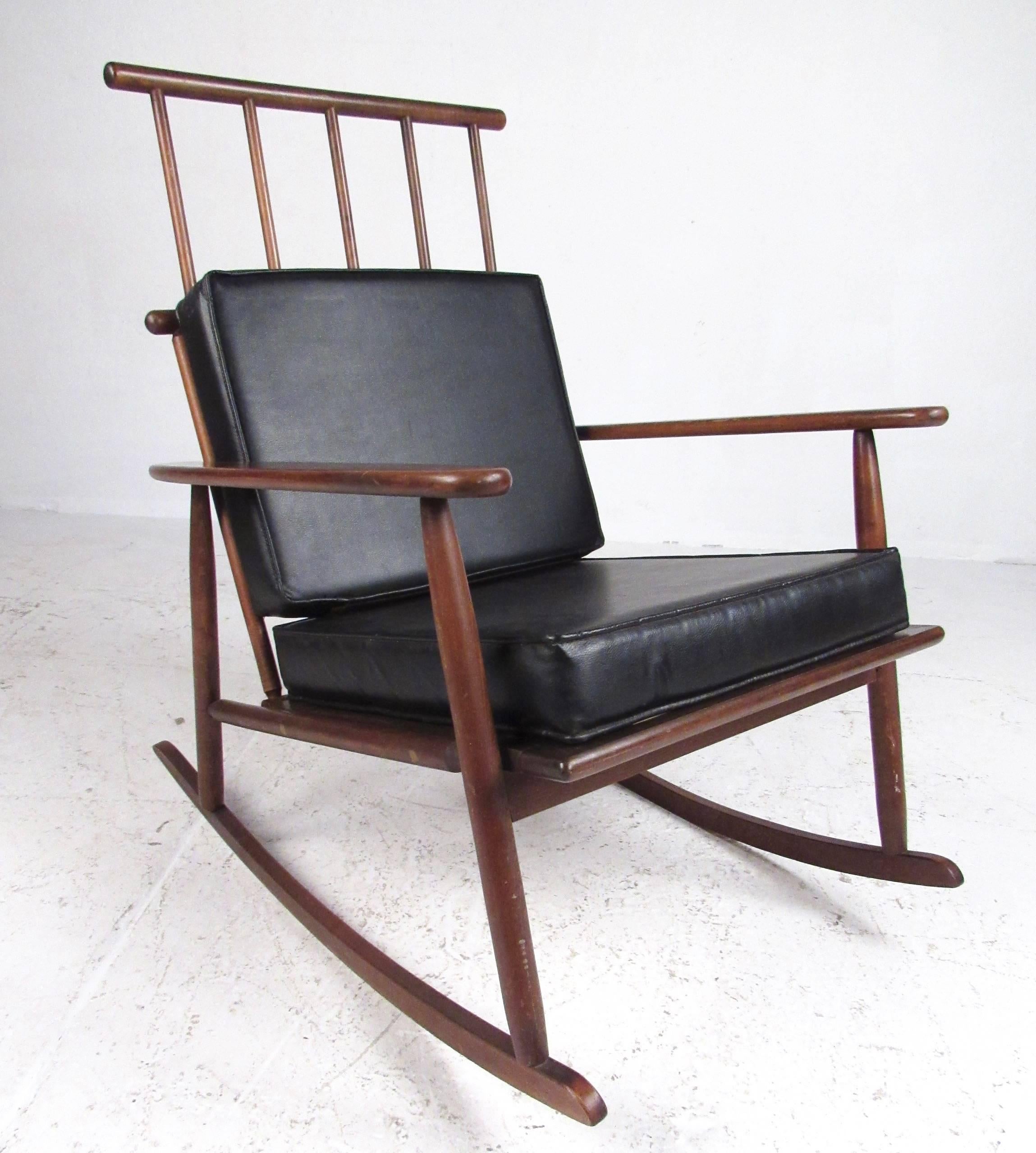 The unique Danish modern design of this midcentury rocking chair makes a striking addition to home or business seating area. Sculptural spoke seat back adds to the distinctive Scandinavian appeal of the rocker. Removable cushions for added comfort,
