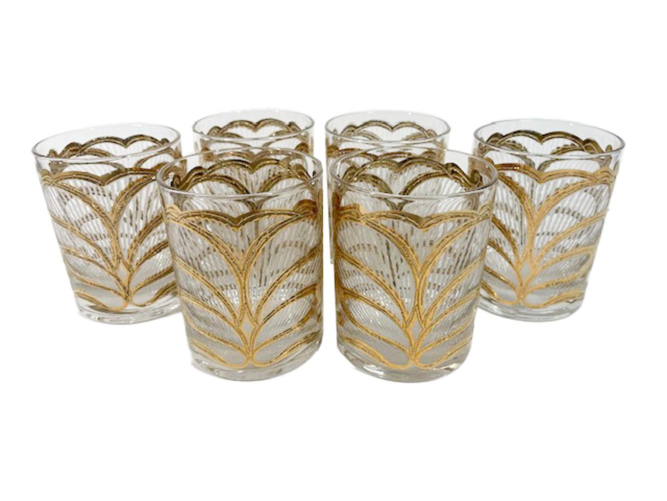 Set of six Mid-Century Modern rocks glasses designed by Georges Briard for his 1966 catalog. Named 'Lotus' the pattern has a stylized flower motif outlined in raised 22k gold with fields on white 'icicle' texture.