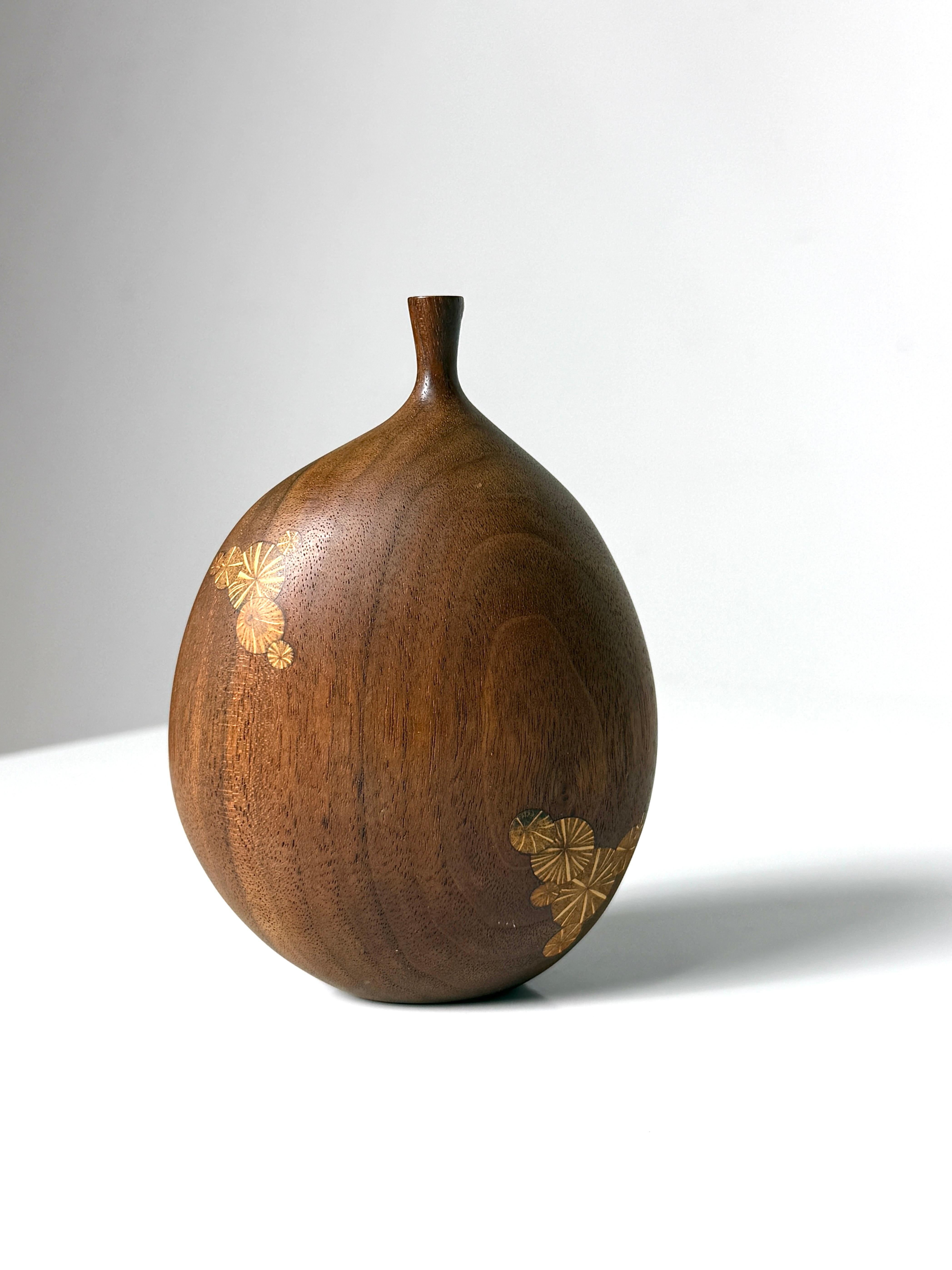 Sculptural turned wood vase by Michigan artist Roger Sloan circa 1970s  
Executed in walnut with Sloan's signature inlaid oak root decoration
A unique form with off center 
Signed to underside

3.5 inch width
2 inch depth
5.25 inch height



