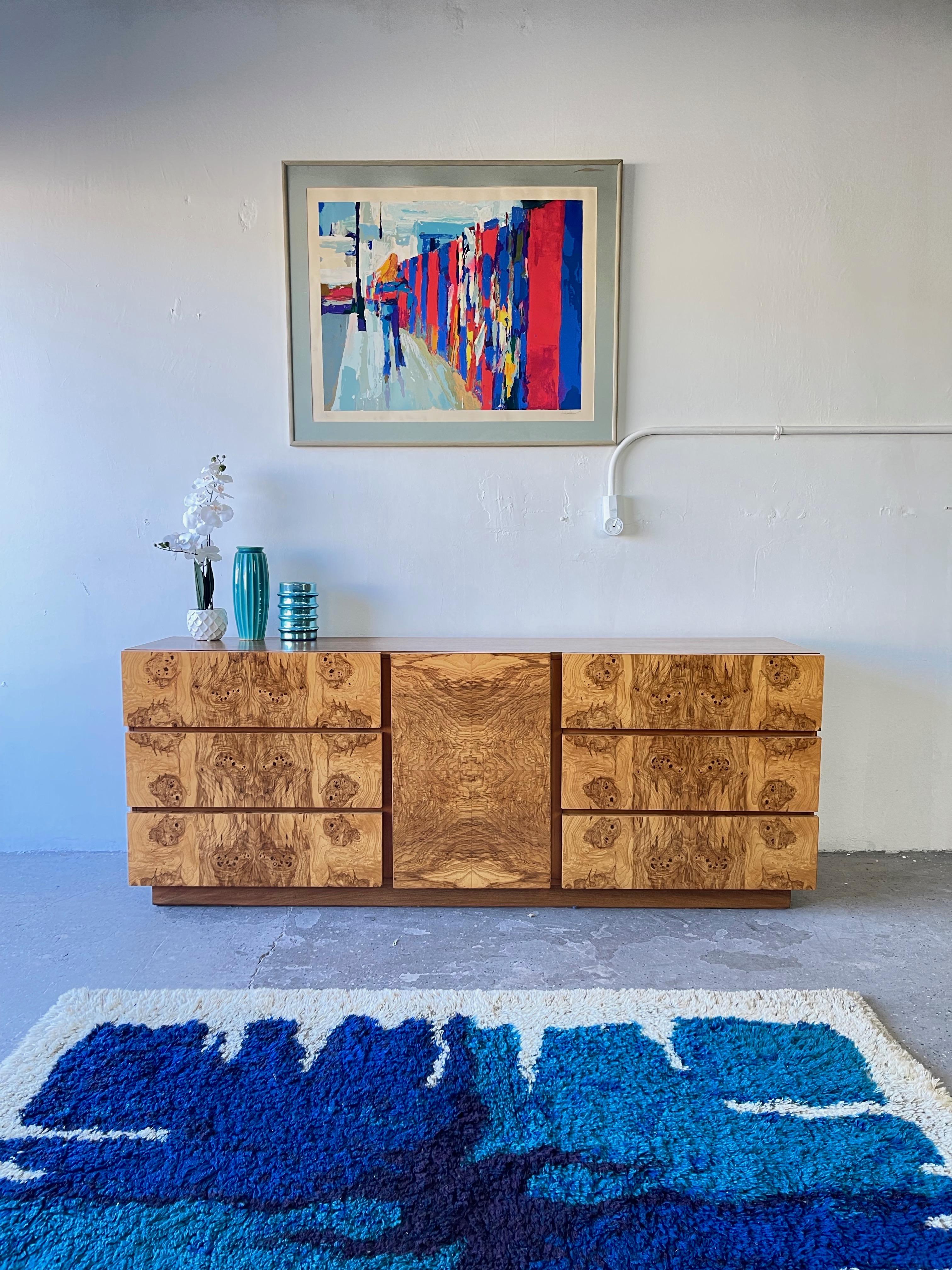 Absolutely gorgeous1970s burl-wood dresser. Three drawers behind middle door flanked on each side by three large drawers. Originally designed by Roland Carter for Lane Furniture, this 