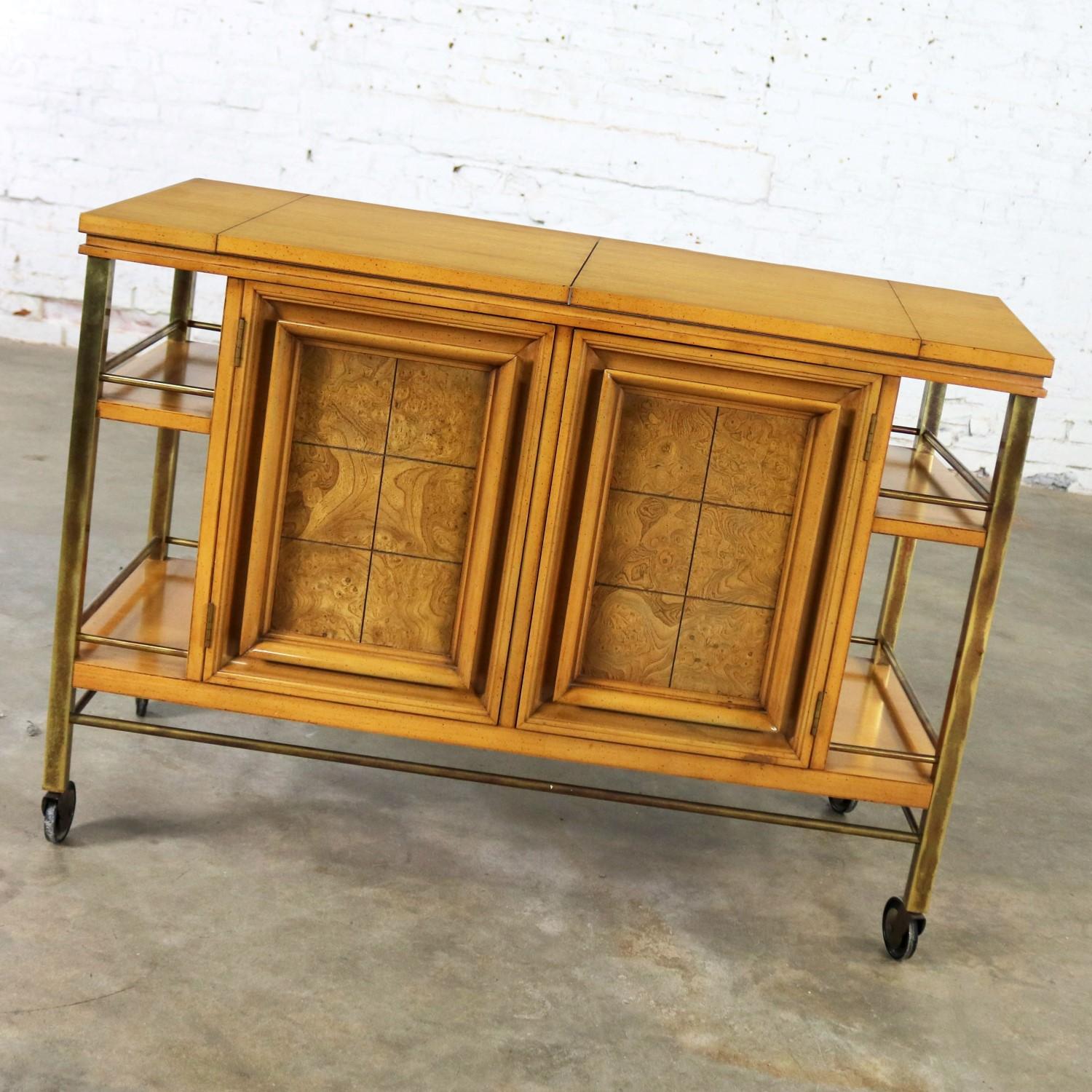 Handsome bar cart, dry bar, or tea cart. It is rolling with storage and a flip open top. Attributed to J. L. Metz Furniture Company from their Contempora line. Made of weathered cherry and brass. It is in fabulous vintage condition with purposeful