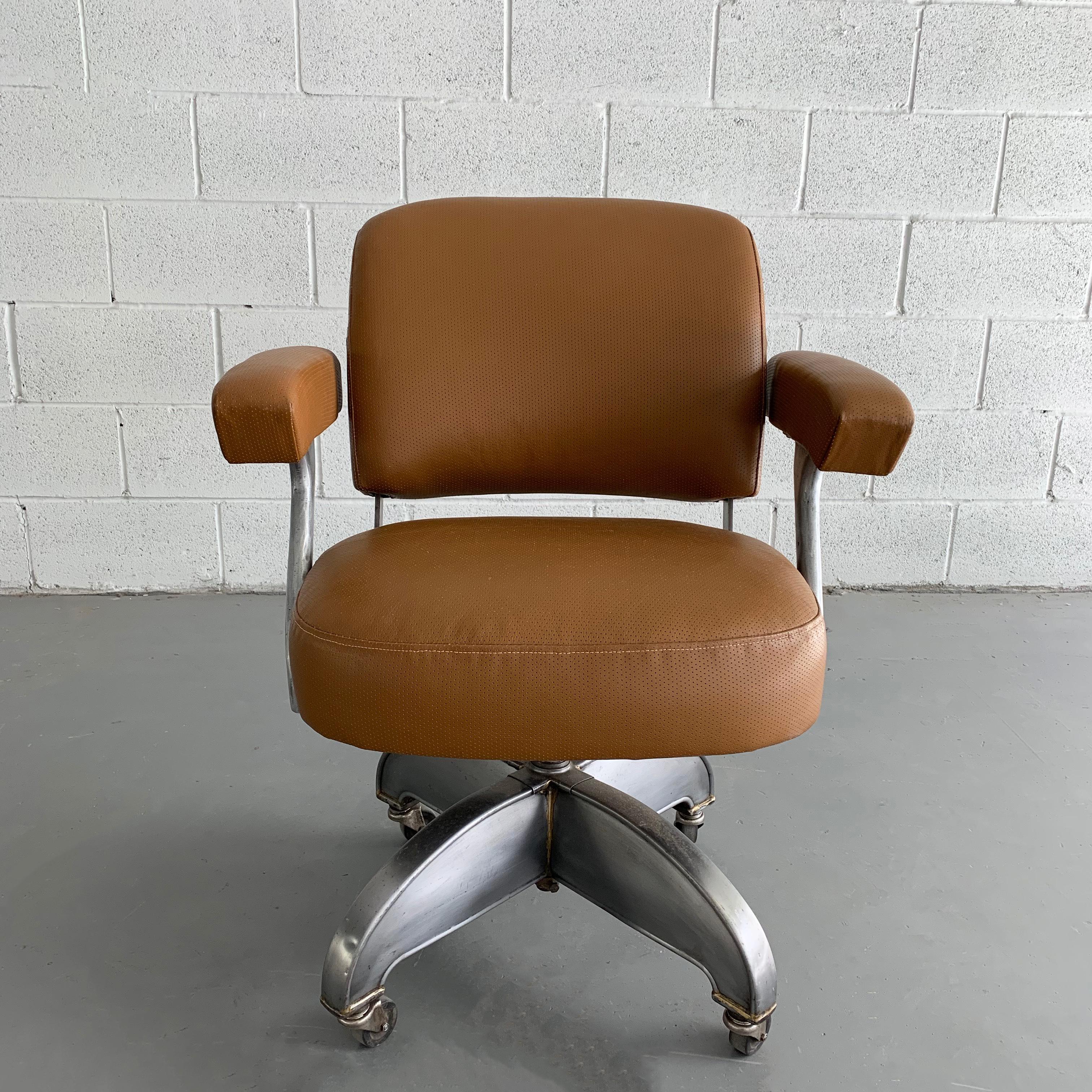 Midcentury, rolling, adjustable height, office, desk armchair by DoMore features an aluminum frame and newly upholstered perforated tan leather seat and back.