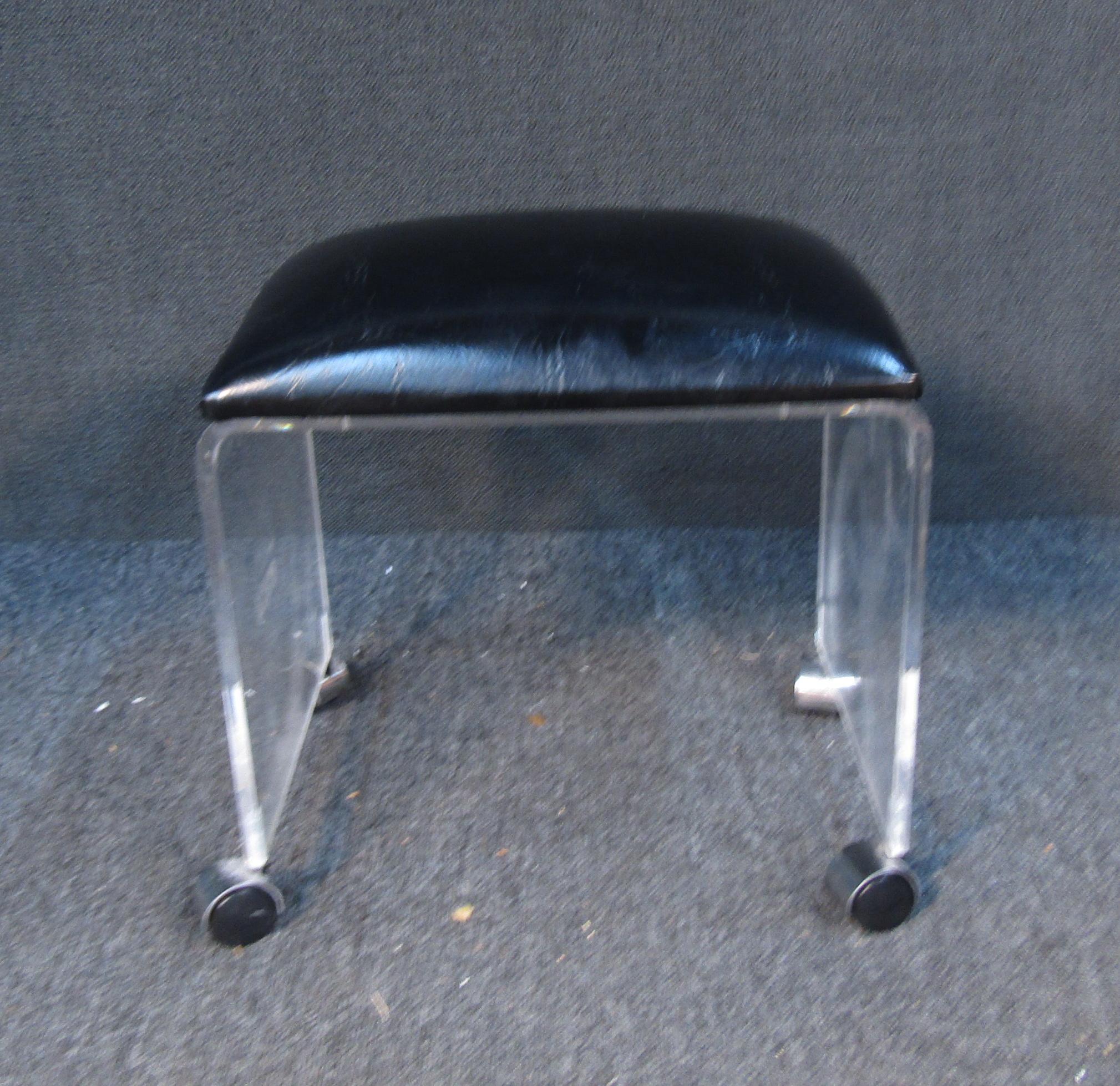 Unique little ottoman-stool on wheels. Black top with two wide fiberglass legs. 

(Please confirm item location - NY or NJ - with dealer).
 