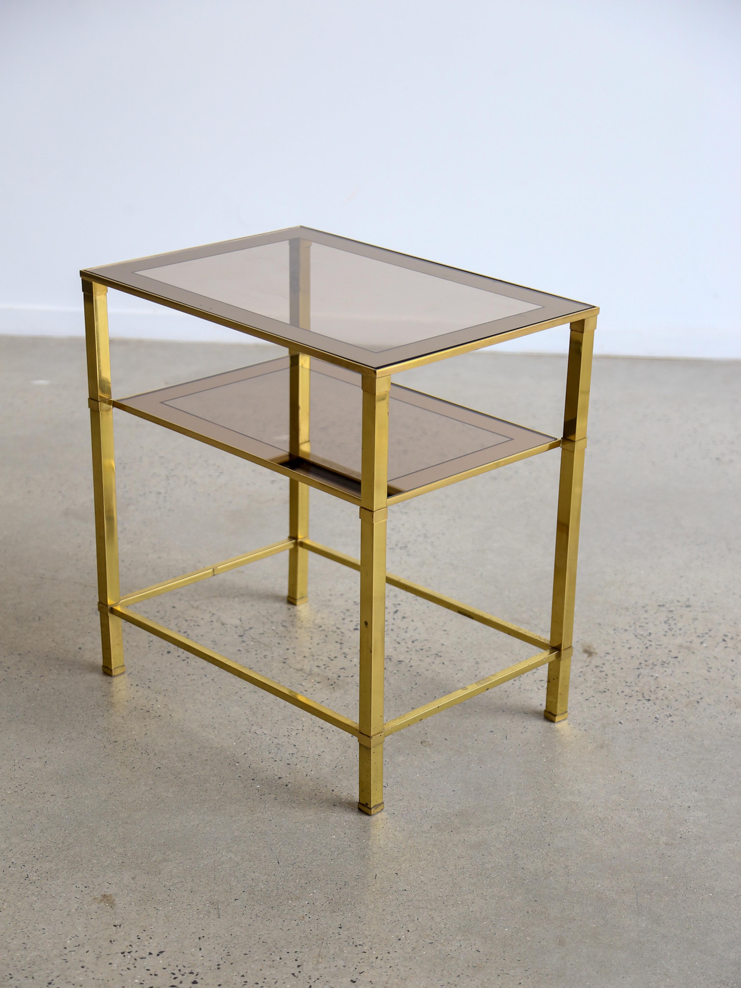 Romeo Rega Italian Mid Century Modern rectangular Brass side table with two smoked glass shelves.

Romeo Rega (1932-1975) was an Italian furniture and lighting designer known for his work in the mid-20th century. He was associated with the modernist