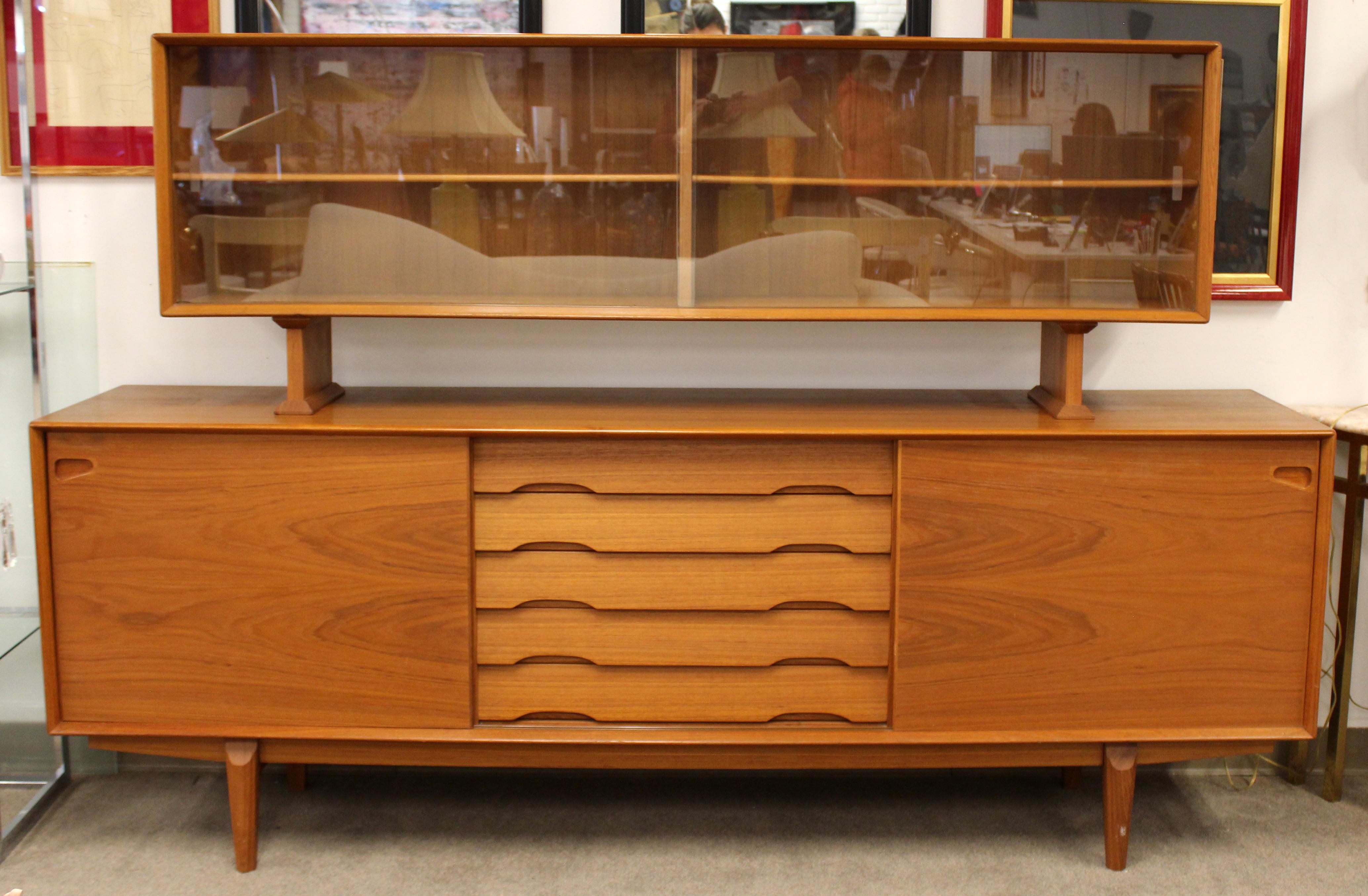 For your consideration is a stupendous and rare, teak credenza, with sliding doors, and a hutch with glass doors, by Rosengren Hansen for Dyrlund, made in Denmark, circa 1960s. In excellent vintage condition. The dimensions are 86.5