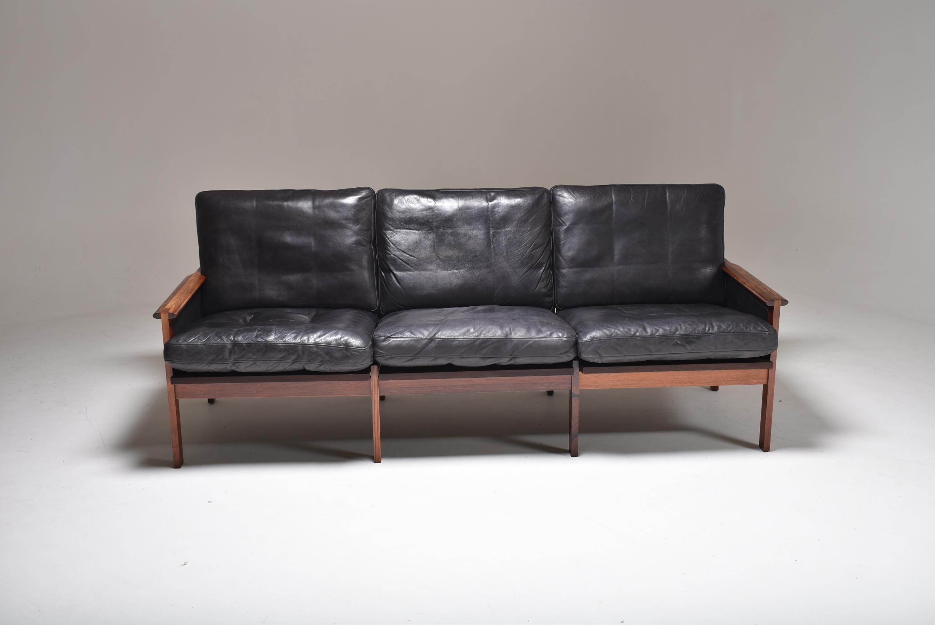 3 seater sofa designed by Illum Wikkelso for Niels Eilersen. 
It is made of solid Brazilian rosewood and original black leather.
Very comfortable and made to last. The frame is very solid and the leather has nice patina.