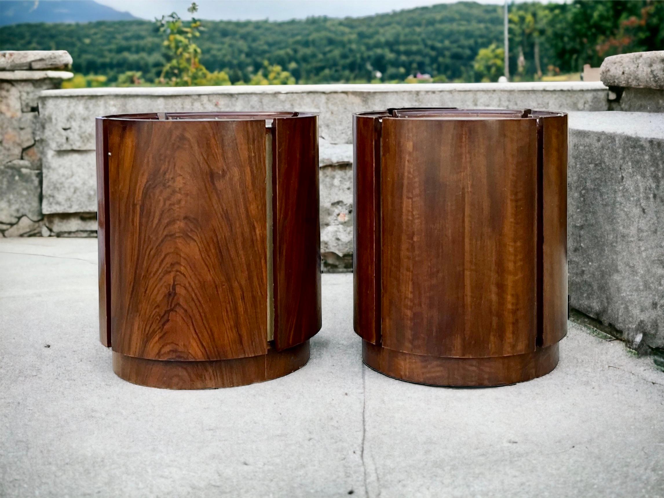 This is an exceptional pair of mid-century modern walnut and brass cylinder form side or drum tables. The tops are brass as well as the recessed exterior inserts. the door swings open to reveal a single shelf. They are unmarked. Note the beautiful