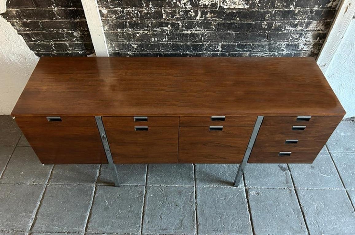 Precioso aparador de mediados de siglo diseñado en los años 70 por Roger Sprunger para Dunbar #1060. Compuesta de exquisita chapa de palisandro y tiradores cromados embutidos y patas de tubo cuadrado. Mucho espacio de almacenamiento en diversas