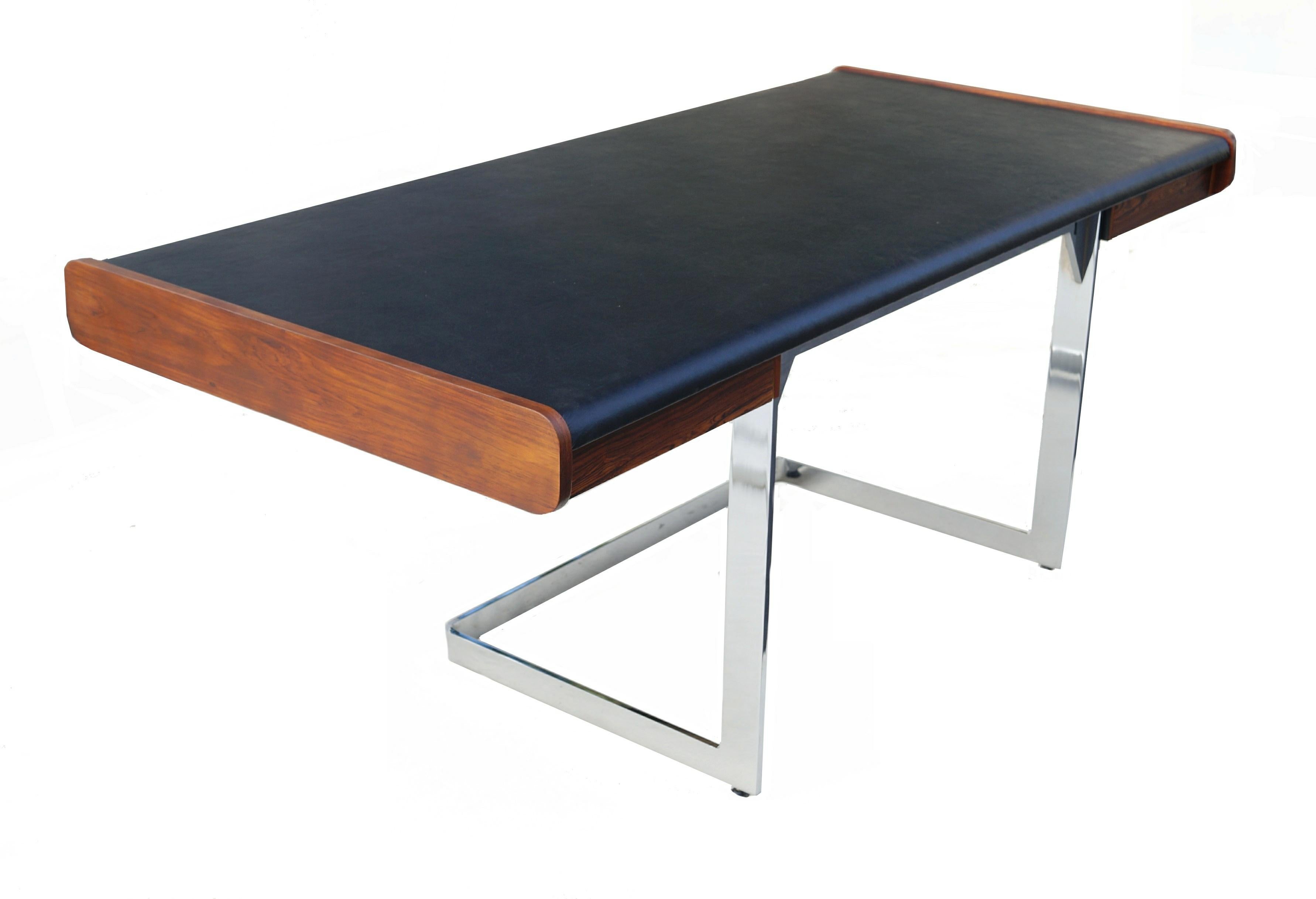 Mid-Century Modern rosewood and chrome desk by Ste. Marie & Laurent. New faux leather vinyl top. The leg opening area is 24.75