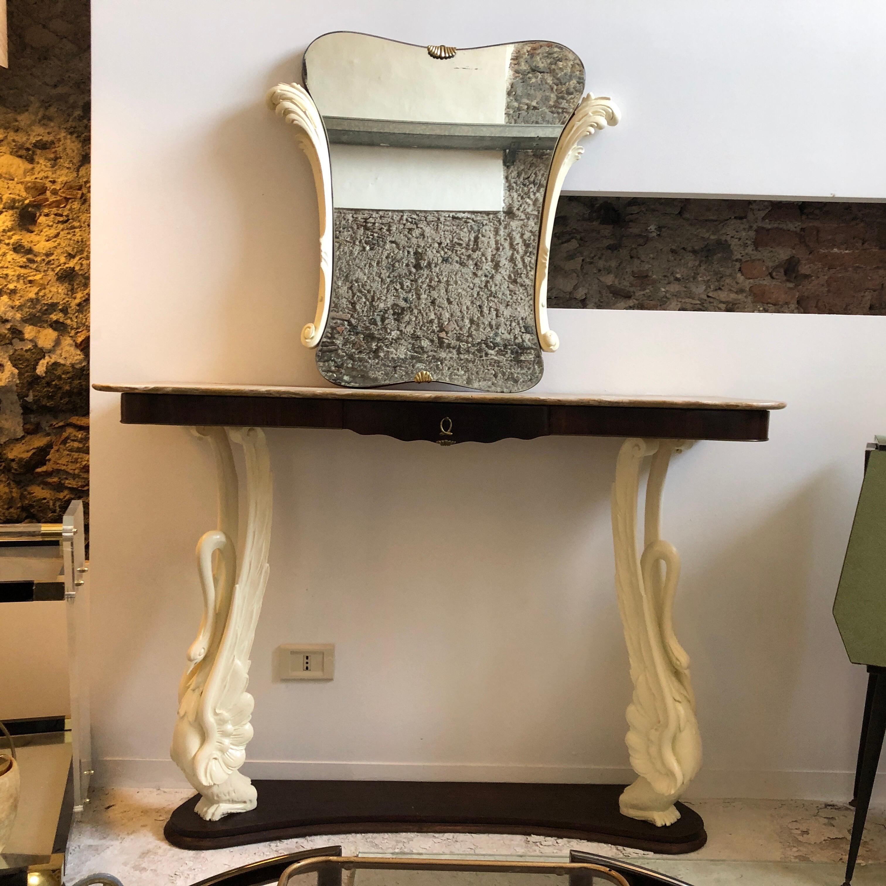 An Italian console with mirror made in the 1950s, two white swans hold up the upper part surmounted by a marble. Mirror dimensions are cm 80 x 60.
Good conditions overall.