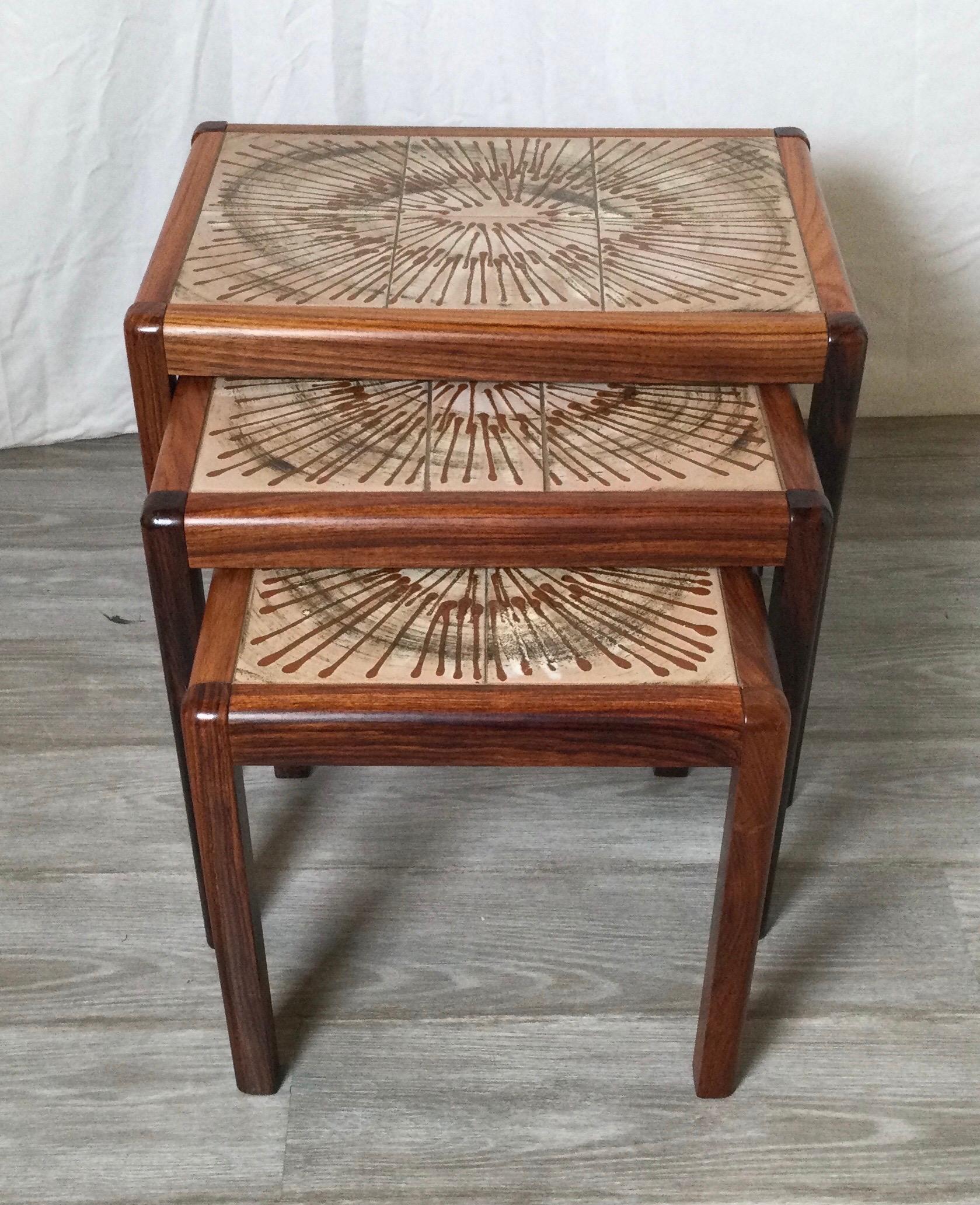 1970's stylish rosewood with burst design tiles. All 3 tables have similar design on tiles. Curved corners, nice construction. The largest table is 20