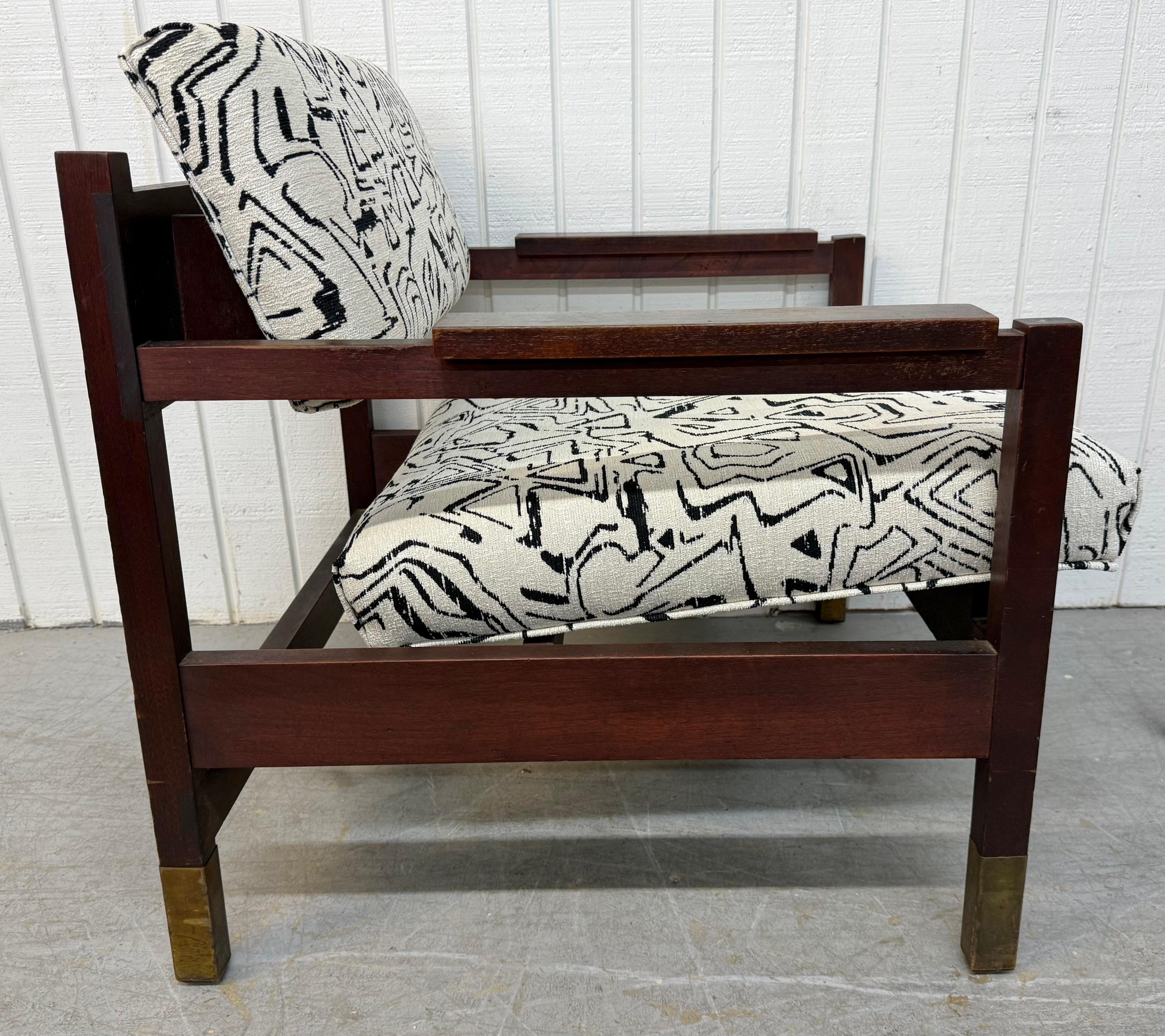 This listing is for a Mid-Century Modern Rosewood Arm Chair. Featuring a straight line design, rosewood frame, new white upholstery with black abstract design, and brass caps on the legs. This is an exceptional combination of quality and MCM design! 