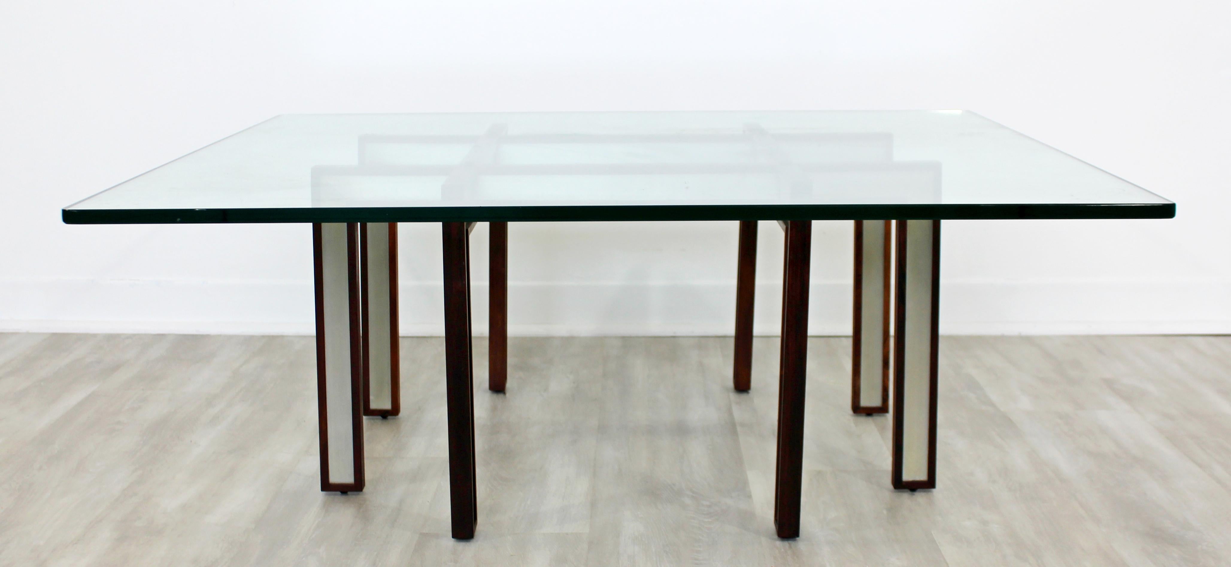 For your consideration is a magnificent, rosewood coffee table, with rosewood and brushed steel base, and a glass top, by Henning Korch, in Denmark, circa 1960s. In excellent condition. The dimensions are 42