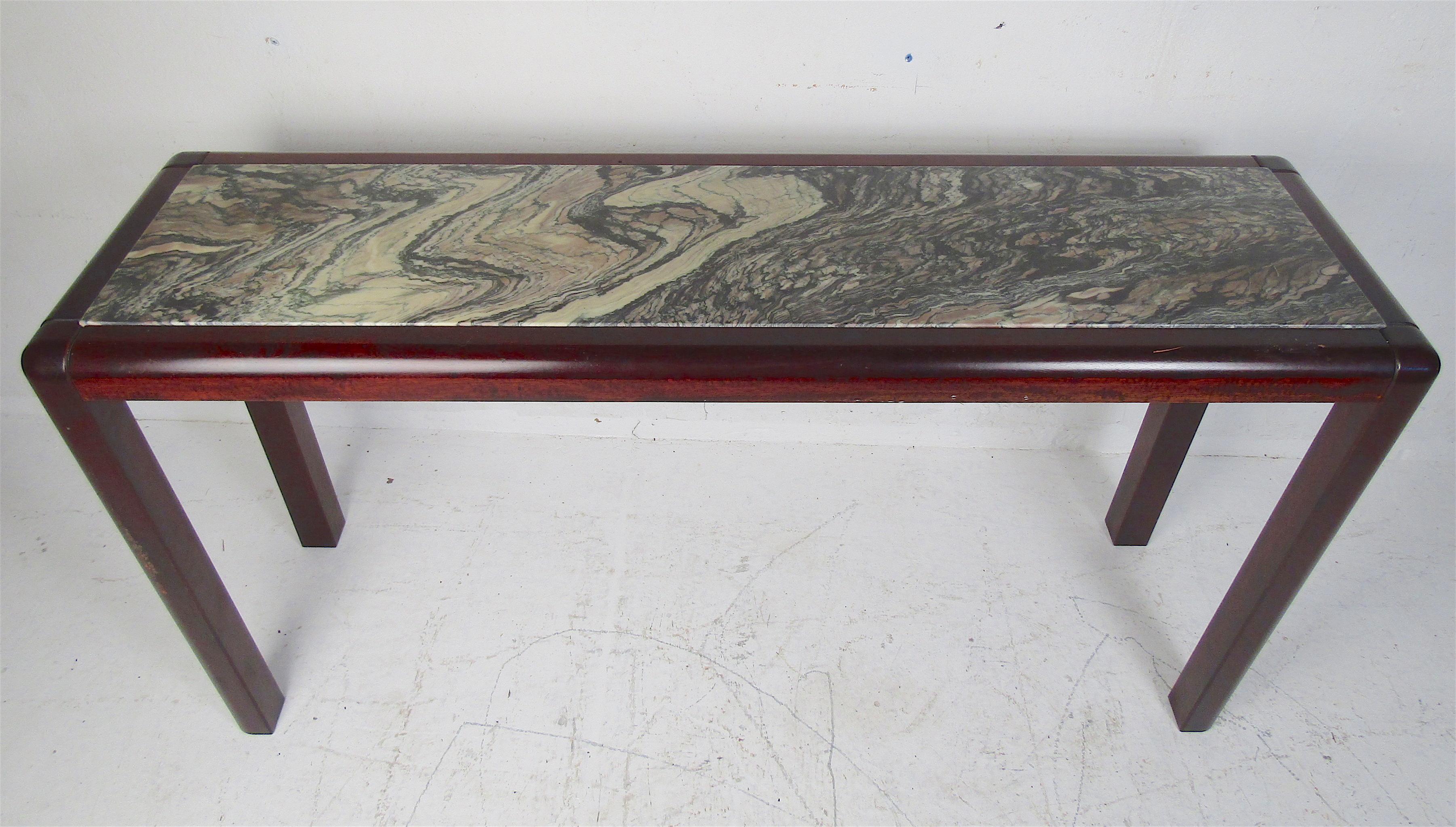 This beautiful vintage modern console table boasts a marble insert top and a rosewood frame. Looks great behind the sofa, in the entry way, or in the hallway. Please confirm item location (NY or NJ).