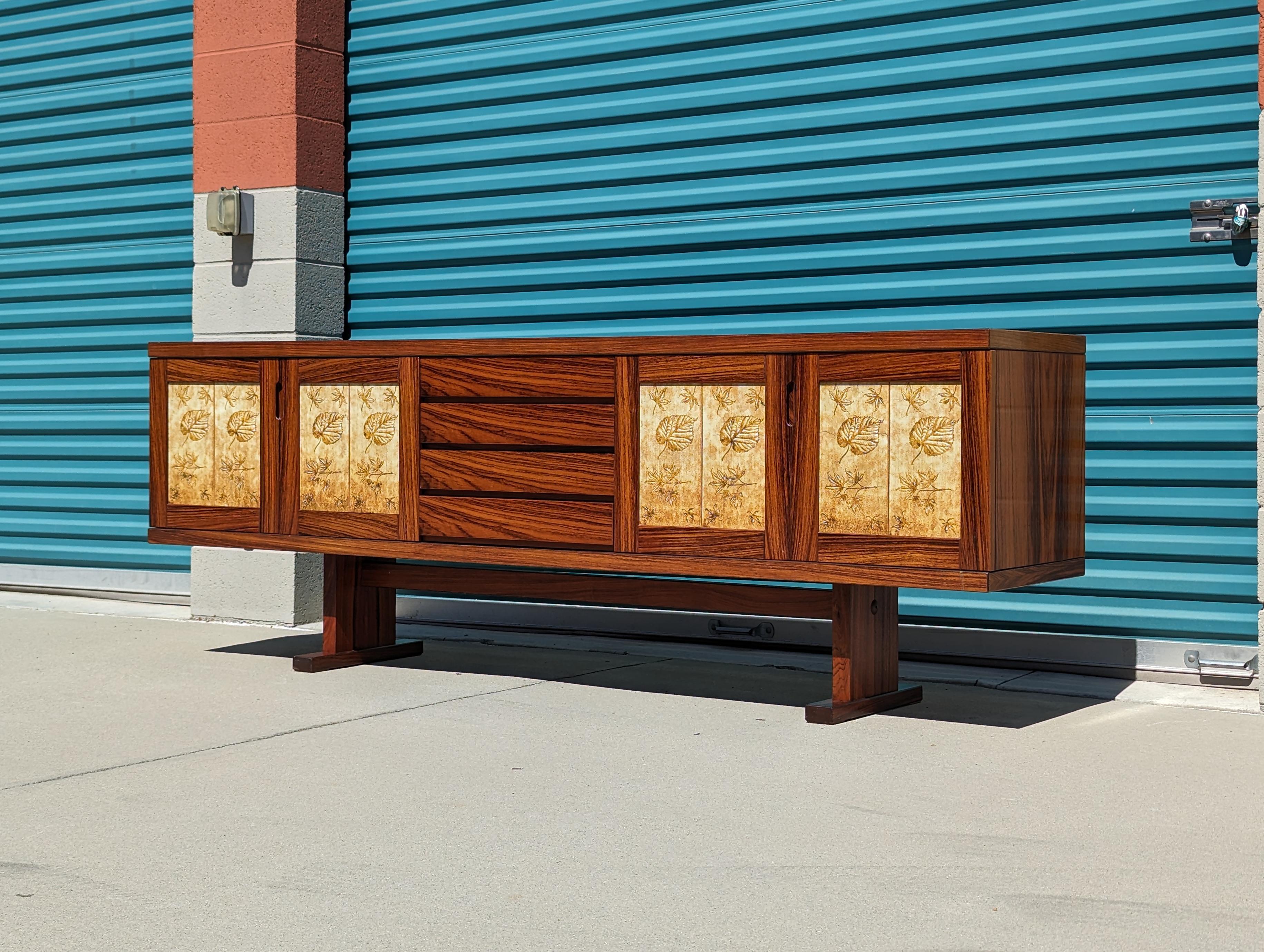 Welcome to the world of timeless elegance with this exquisite vintage mid-century modern rosewood credenza/buffet designed by Poul H. Poulsen for Gangso Mobler. Crafted with meticulous attention to detail, this stunning piece showcases the perfect