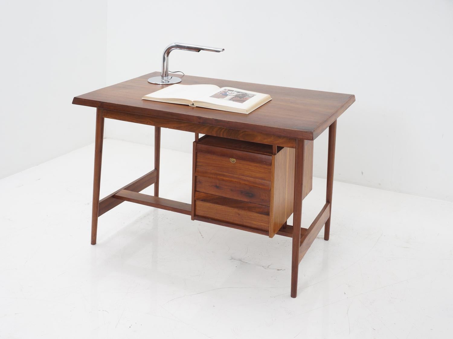 Are you tired of boring, uninspired desks? Look no further than this stunning 1950s rosewood desk. The craftsmanship and attention to detail are undeniable, from the smooth locking drawers to the beautiful wood grain. And let's not forget about the