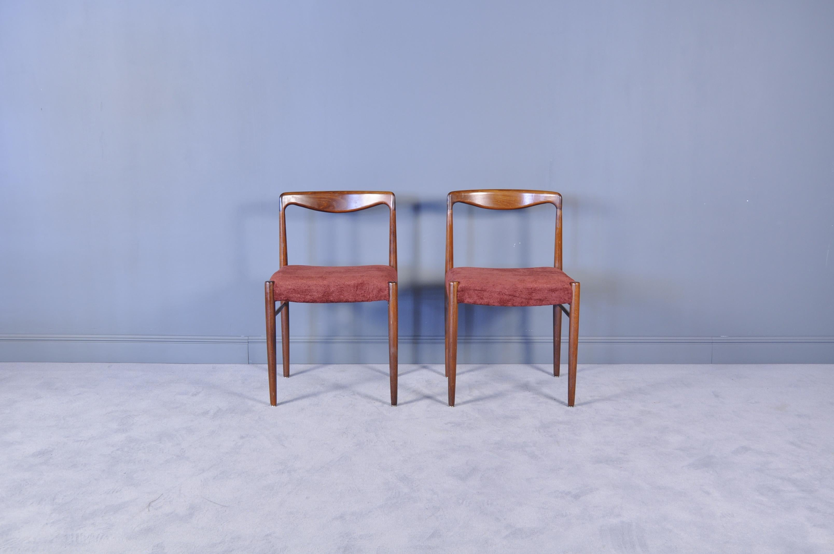 This set of eight dining chairs were manufactured in the 1960s in Germany by Lübke. The chairs are made of solid rosewood in a minimalist design.