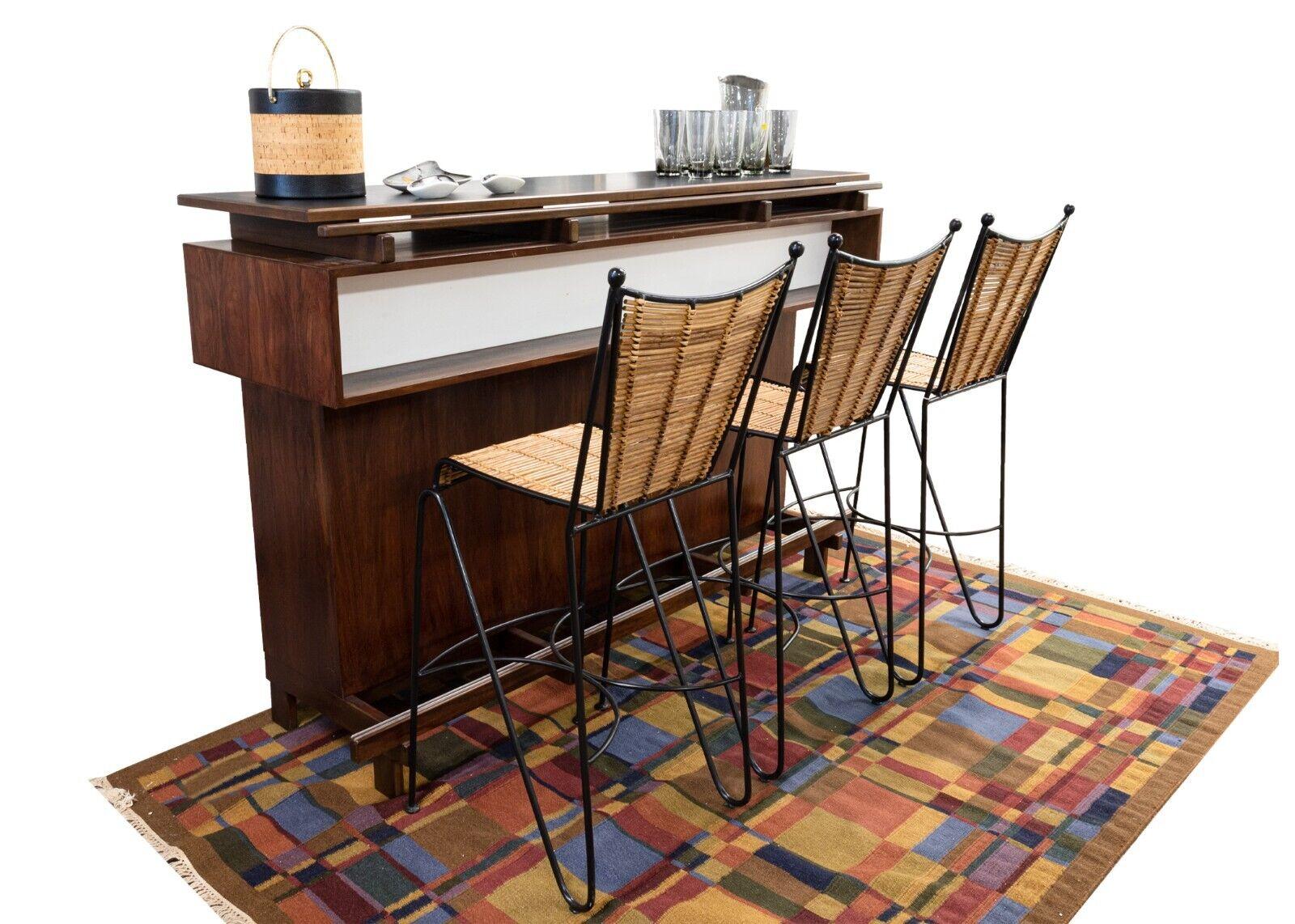 A rosewood dry bar from Erik Buch for Dyrlund Denmark. A truly fantastic mid century modern bar for any MCM home. This wonderful piece features Danish design from Erik Buch. This piece is constructed with primarily rosewood, which has such deep,