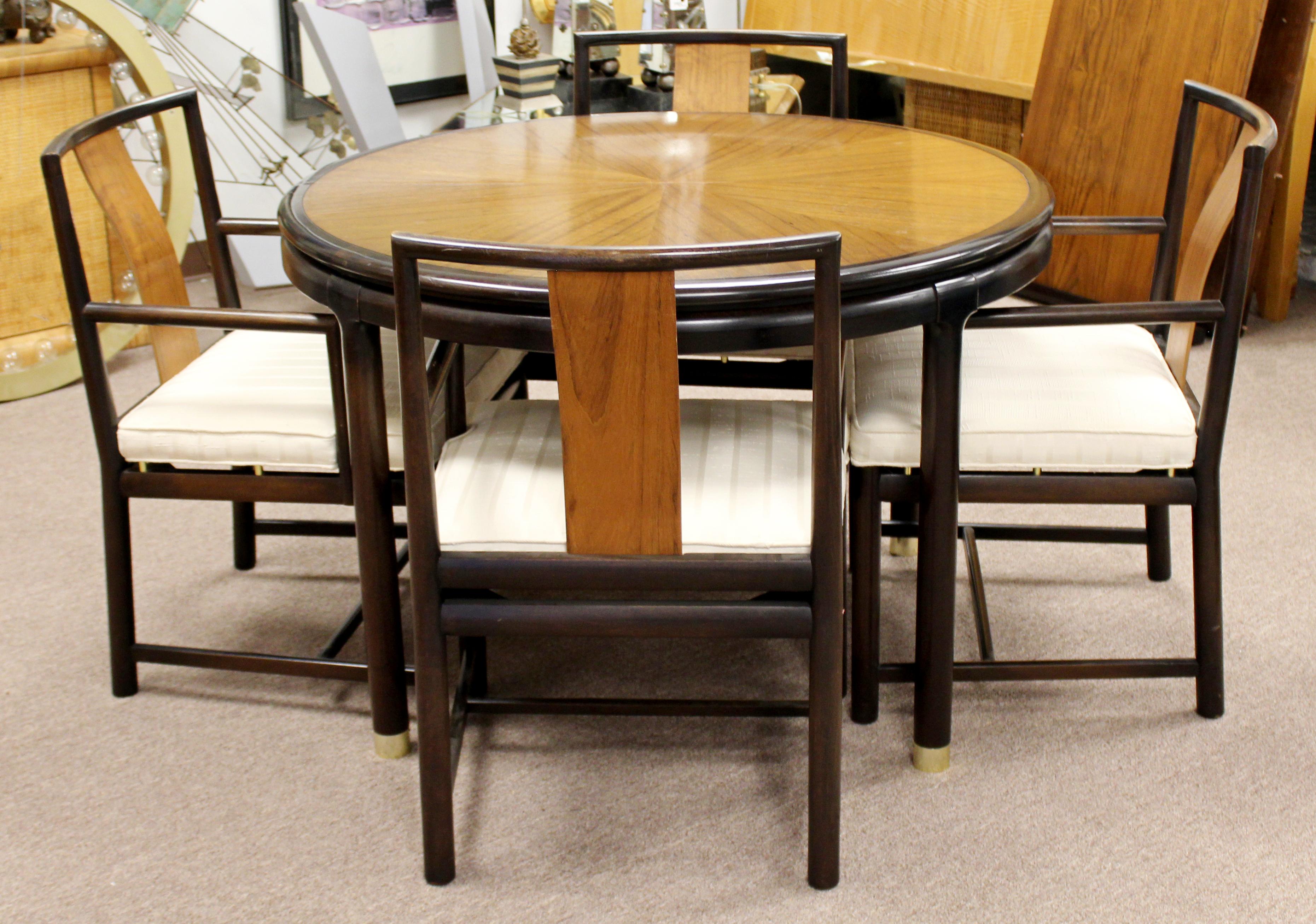 For your consideration is an extraordinary dinette set, including an expandable table with two leaves, and four matching armchairs, attributed to Baker or Dunbar, circa 1960s. In very good vintage condition. The dimensions of the table are 44