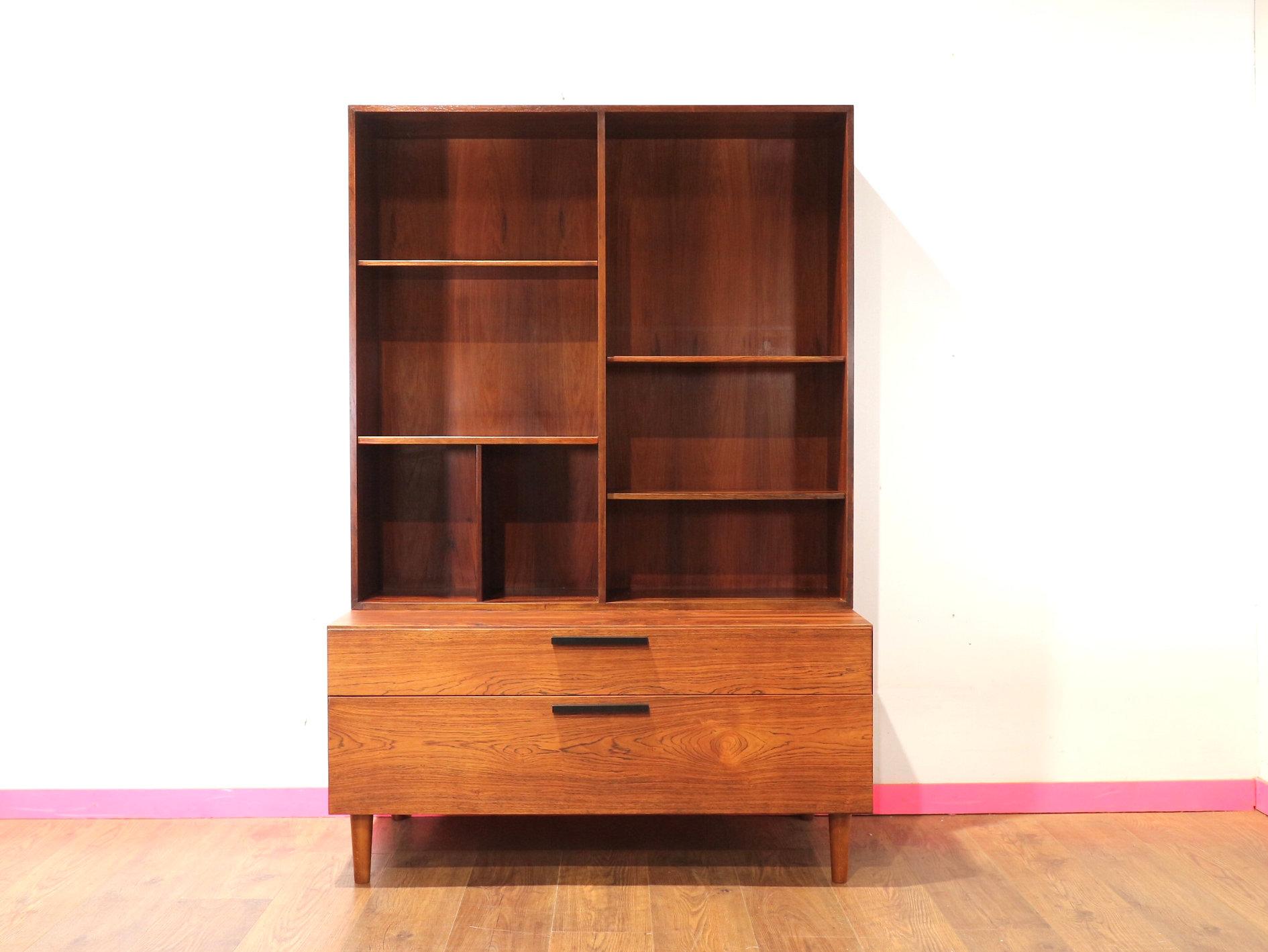 Discover the timeless elegance of this Mid Century Modern Rosewood Kofod Larsen Display China Cabinet Bookcase at Mid Century Traders. A display china cabinet wall unit by Ib Kofod-Larsen for Faarup Møbelfabrik from Denmark 1960s, this exquisite