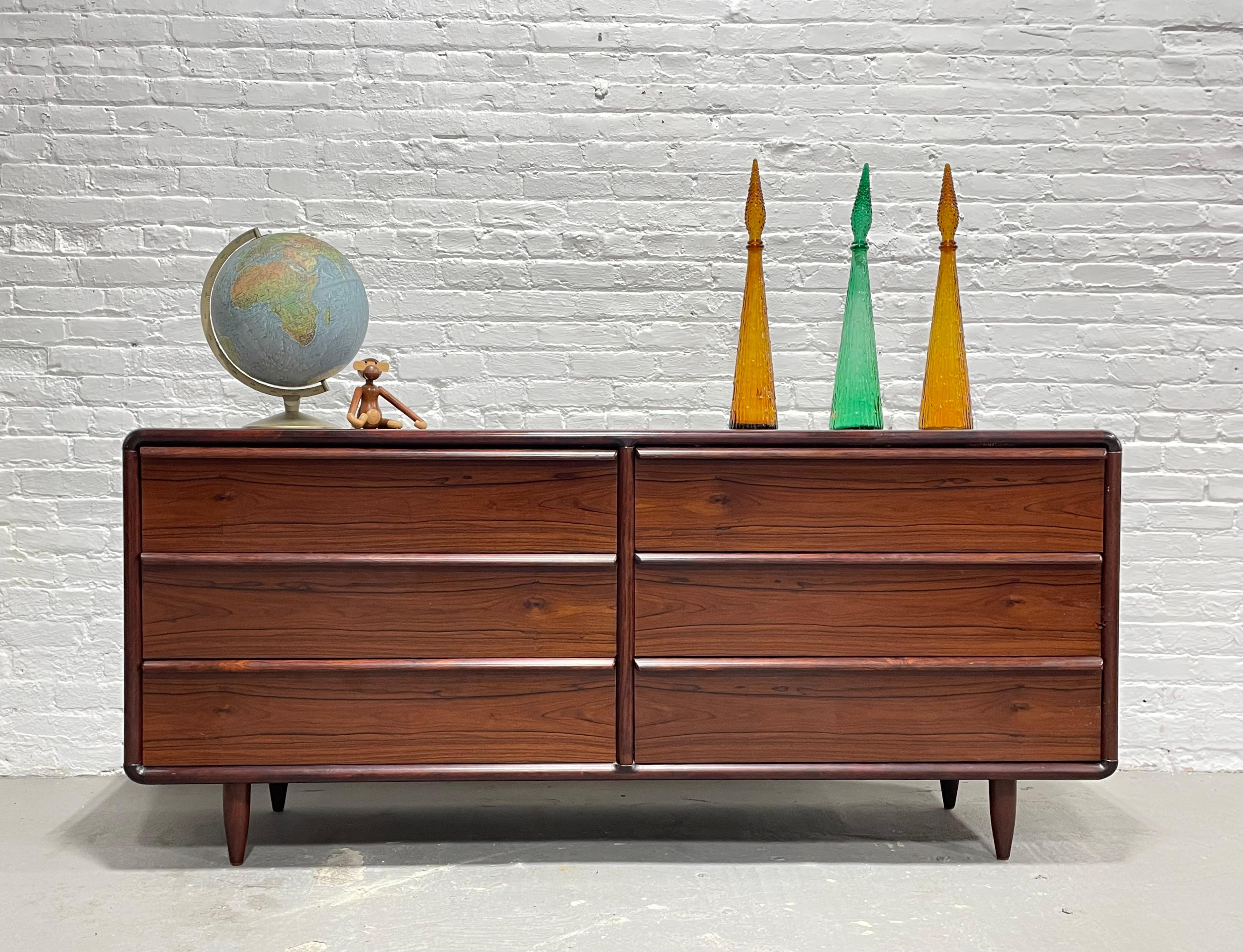 Incredible Mid Century Modern Rosewood Double Dresser by Kibaek Mobelfabrik, c. 1960's. This piece features some of the most stunning wood grains we have ever seen. Constructed in rosewood and its deep, rich color and stunning wood grains will add