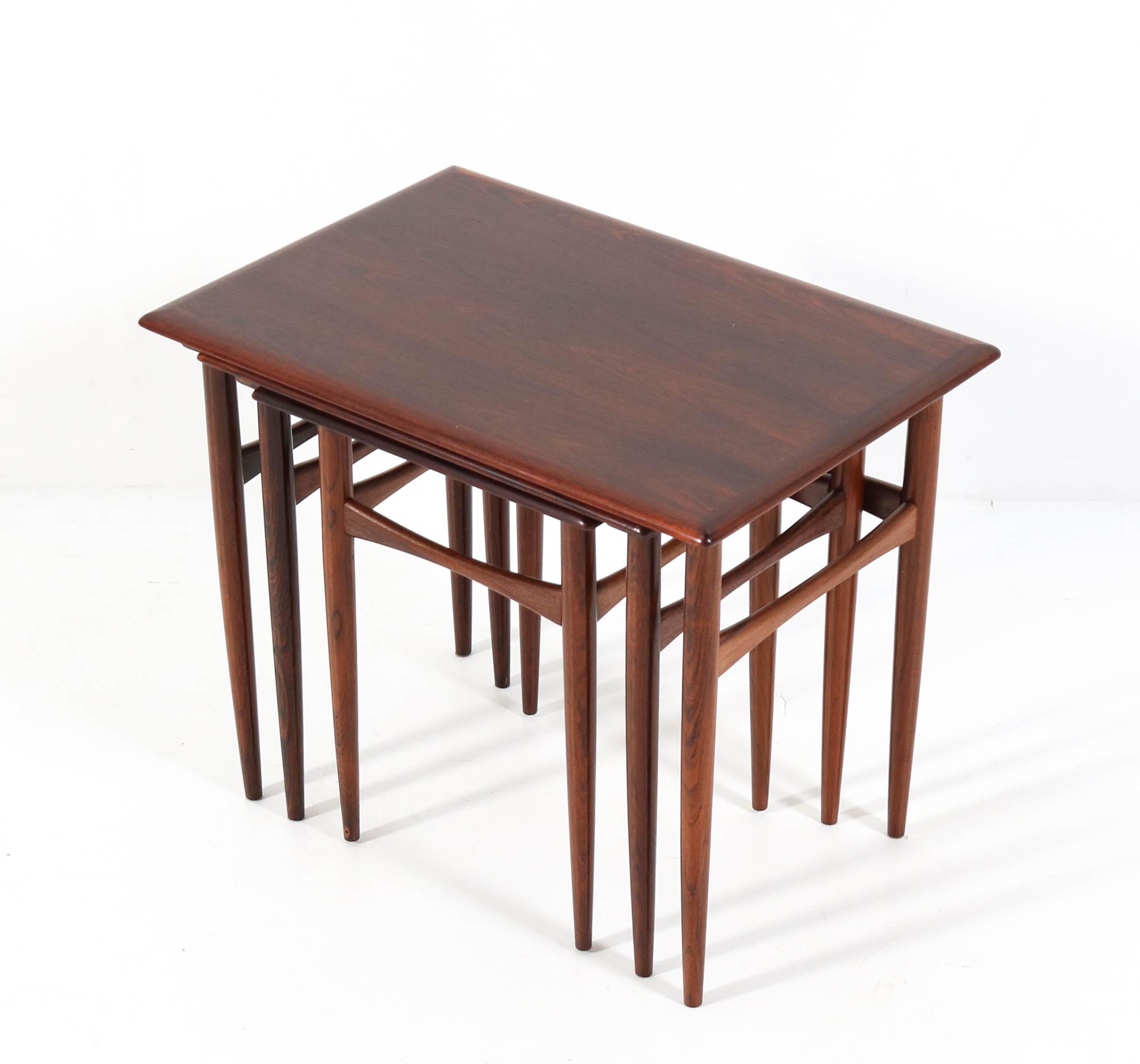 Wonderful set of three Mid-Century Modern nesting tables.
Design by Arne Hovmand Olsen.
Striking Danish design from the 1960s.
Solid rosewood nicely shaped legs with original rosewood veneered tops.
In very good refinished condition with a