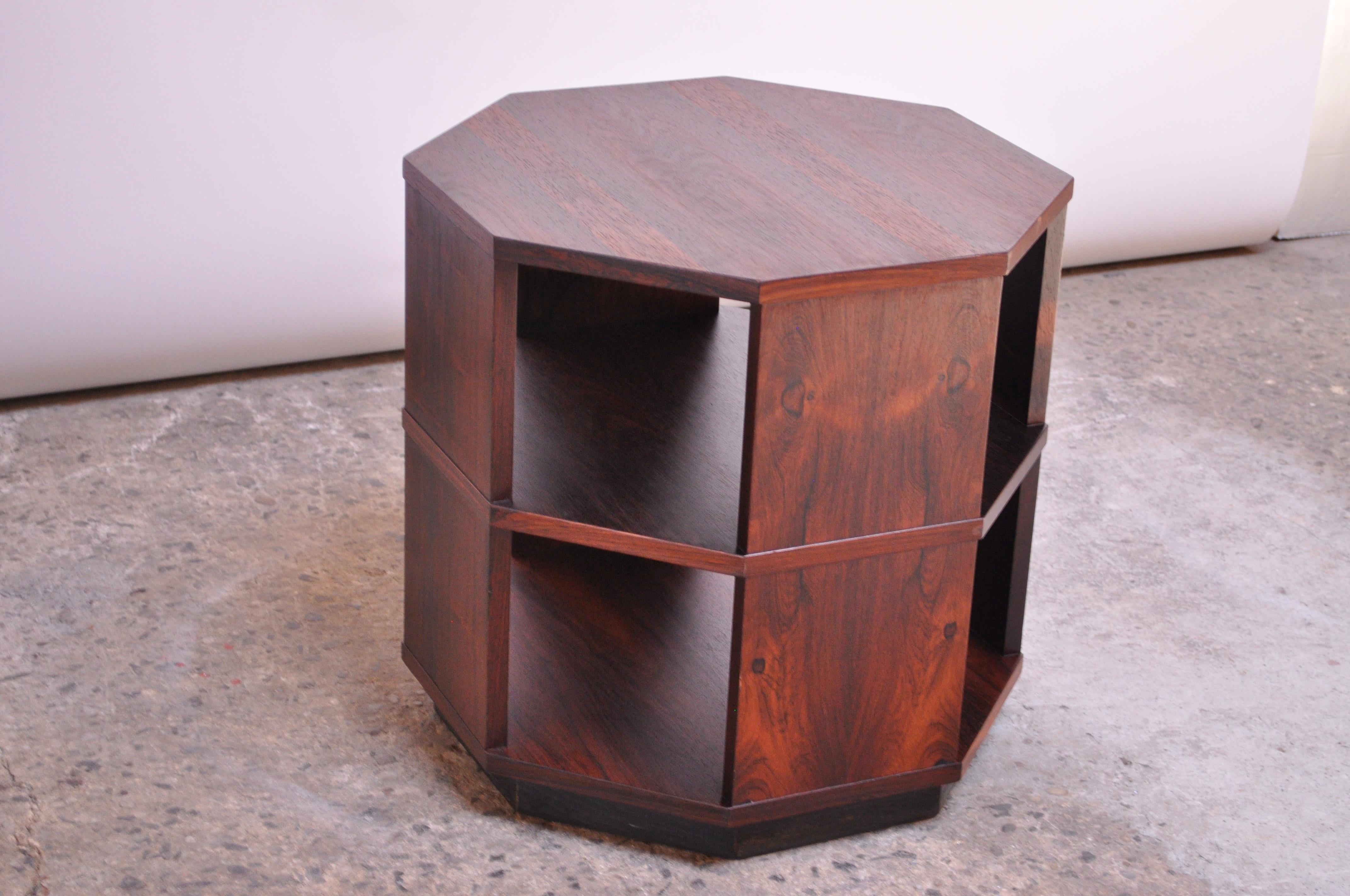 Rosewood octagon-form occasional / side table on black, plinth base. Features two tiers with four open sides; ideal for display purposes, given the exposures. Reminiscent of Harvey Probber designs, but unmarked. Likely Scandinavian circa 1960s.