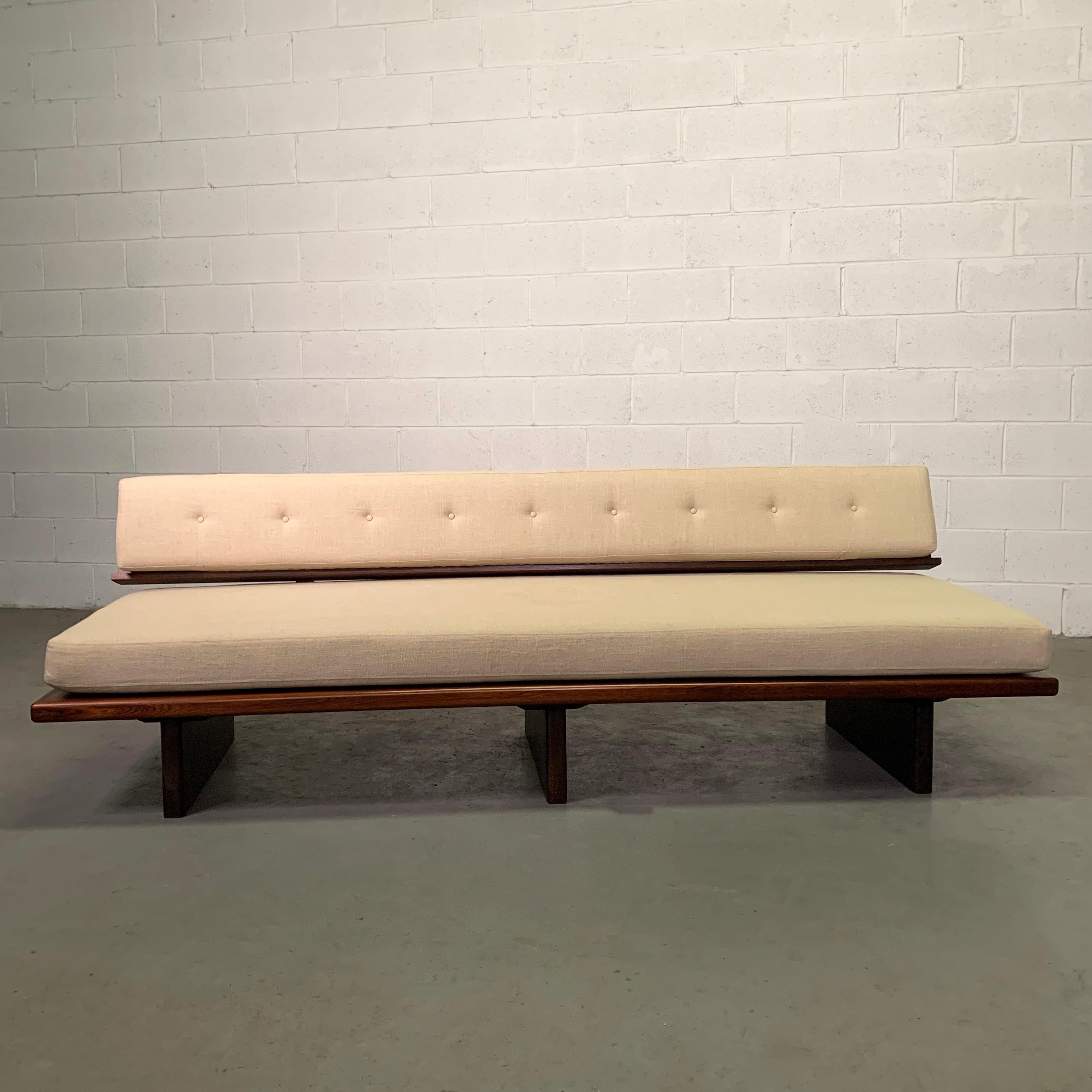 Mid-Century Modern, Brazilian sofa or daybed features a rosewood platform base with a floating back connected by steel brackets is newly upholstered in oatmeal beige linen. This sofa is gorgeous from all angles. 