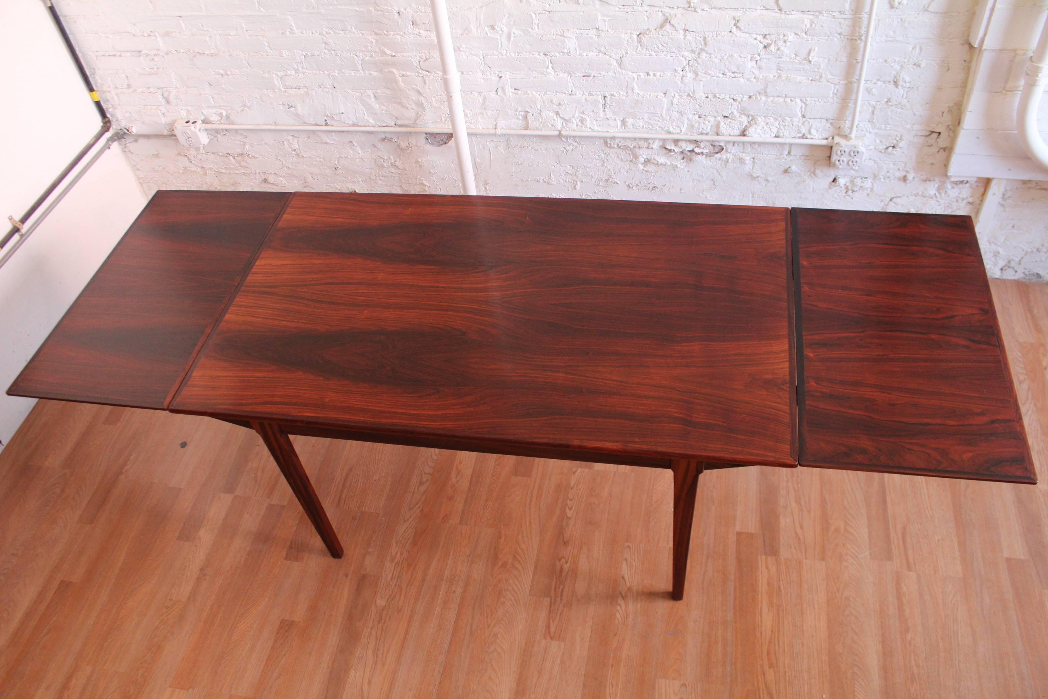 Rosewood refectory table with two self storing leaves. Stunning. 
The leaves measure approximately 19 inches each.