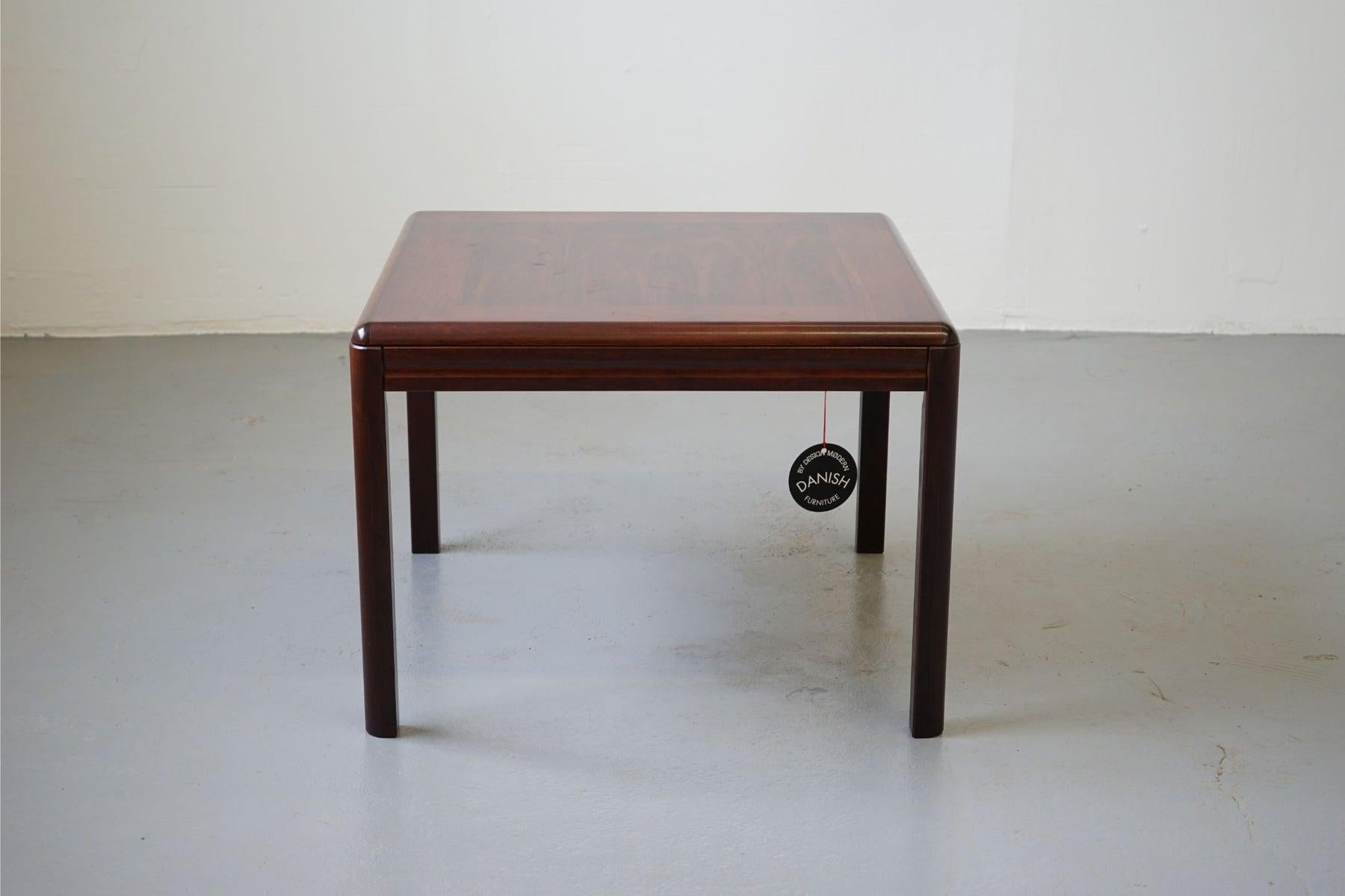 Rosewood table circa 1970s. Compact yet highly functional table pairs perfectly with lounge chairs, loveseats or larger sofas or anywhere extra surfaces are needed. Legs are easily removed for compact moving or storage.

Unrestored item, some