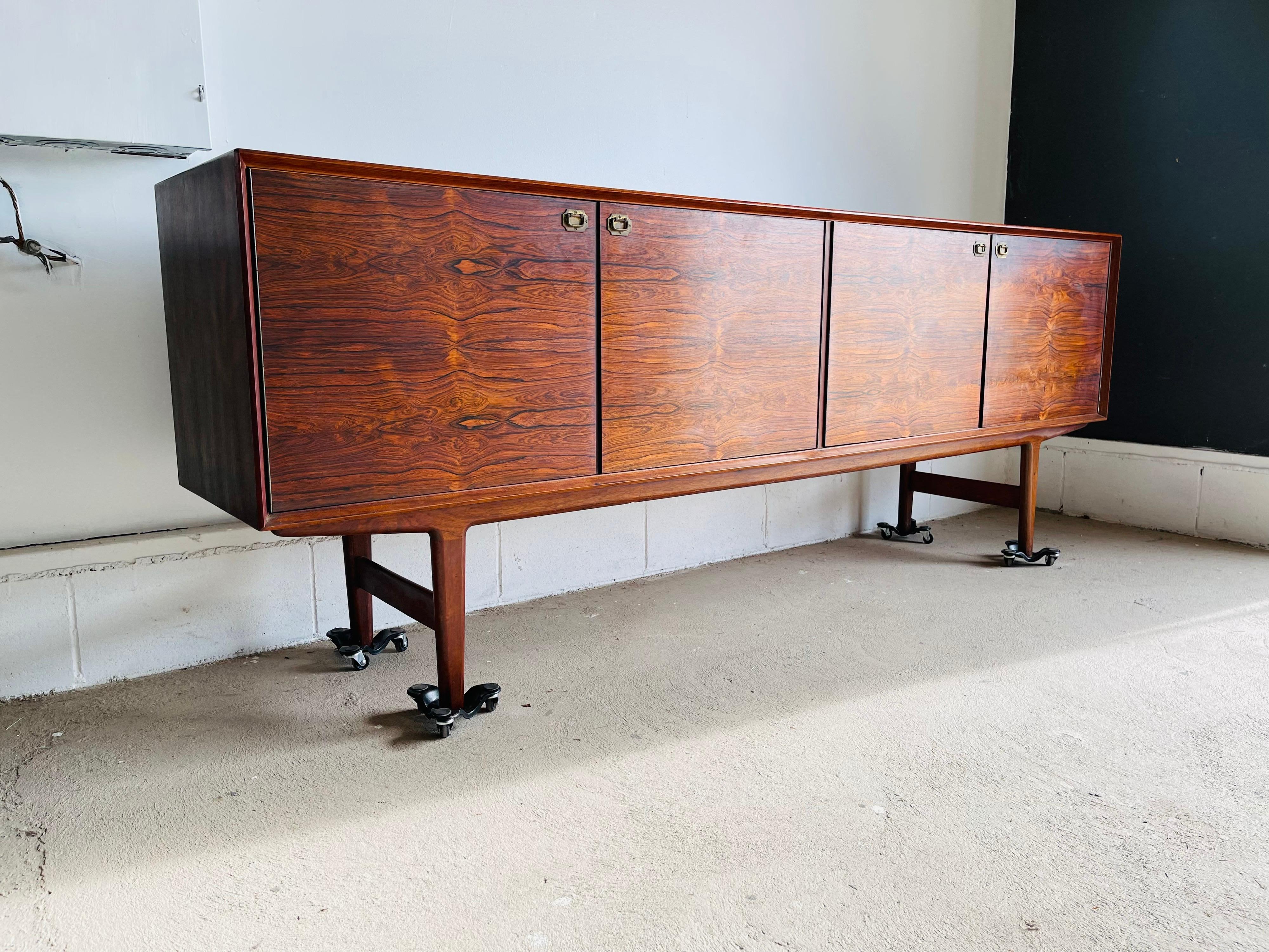 Here is a stunning and rare mid-century modern Rosewood sideboard / credenza by Fredrik Kayser of Sweden for Viken Mobelfabrik. This gorgeous credenza features two sets or doors that open to plenty of storage space and 5 rosewood drawer behind the