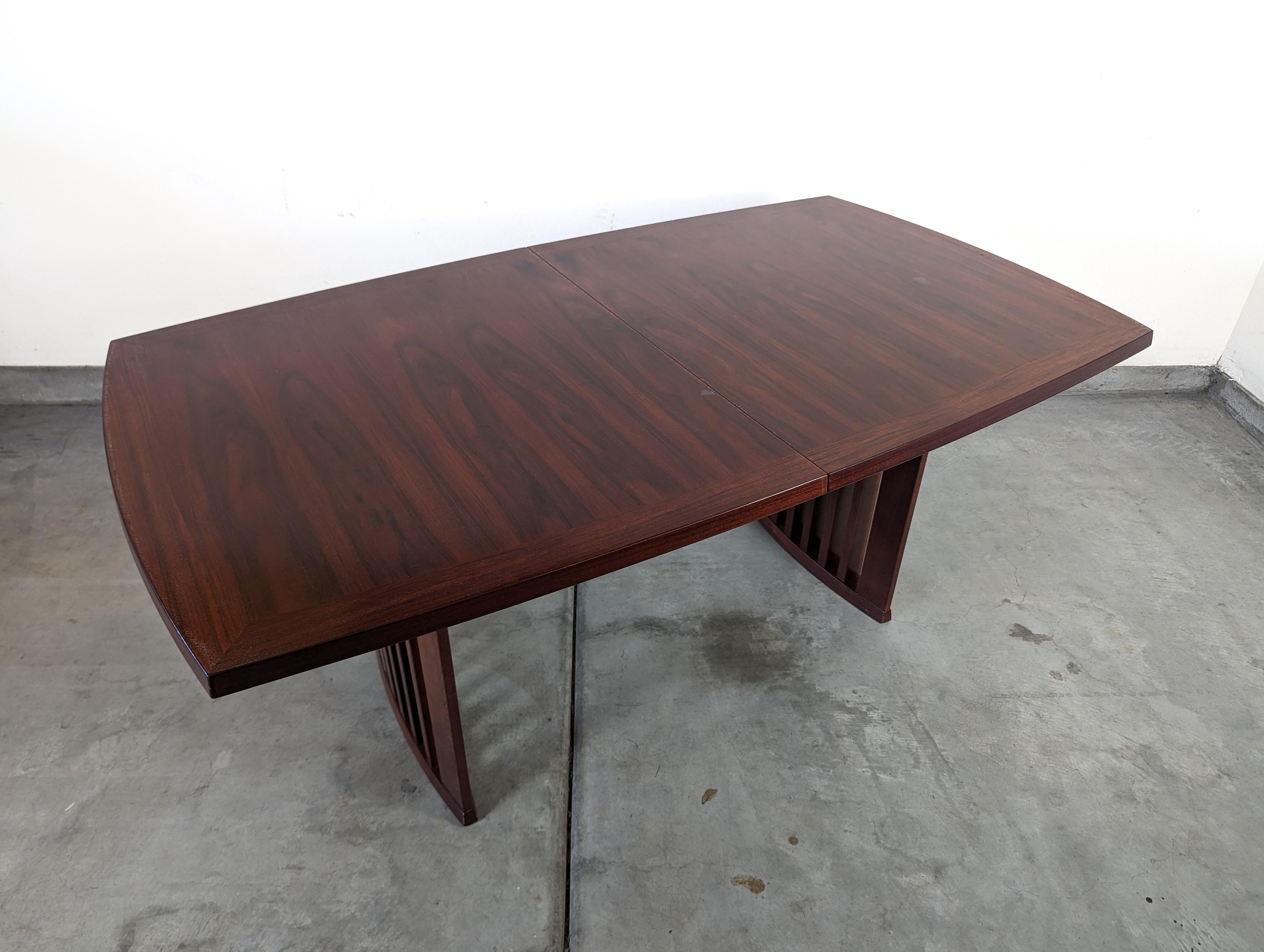 Enhance your dining experience with this exquisite vintage mid century Skovby #19 dining table. Crafted with exceptional attention to detail, this Danish masterpiece combines timeless design with ingenious functionality. Its unique feature allows