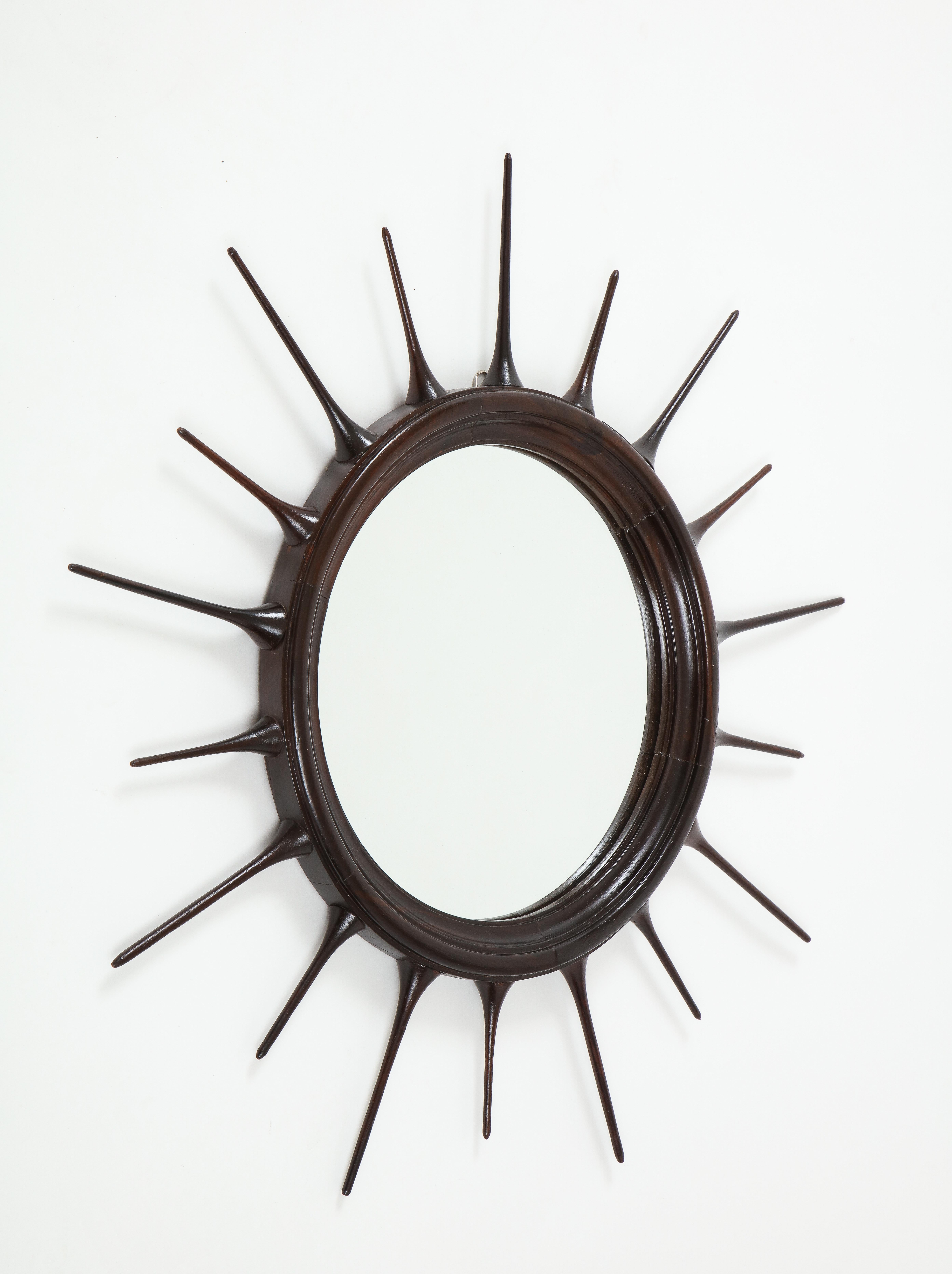 Mid-Century Modern wood sunburst mirror, Brazil, 1950s

1950s Brazilian Mid-Century Modern sunburst mirror, with finely crafted frame typical of the period. The frame is carved in solid wood with a simple yet elegant radial pattern, finished with