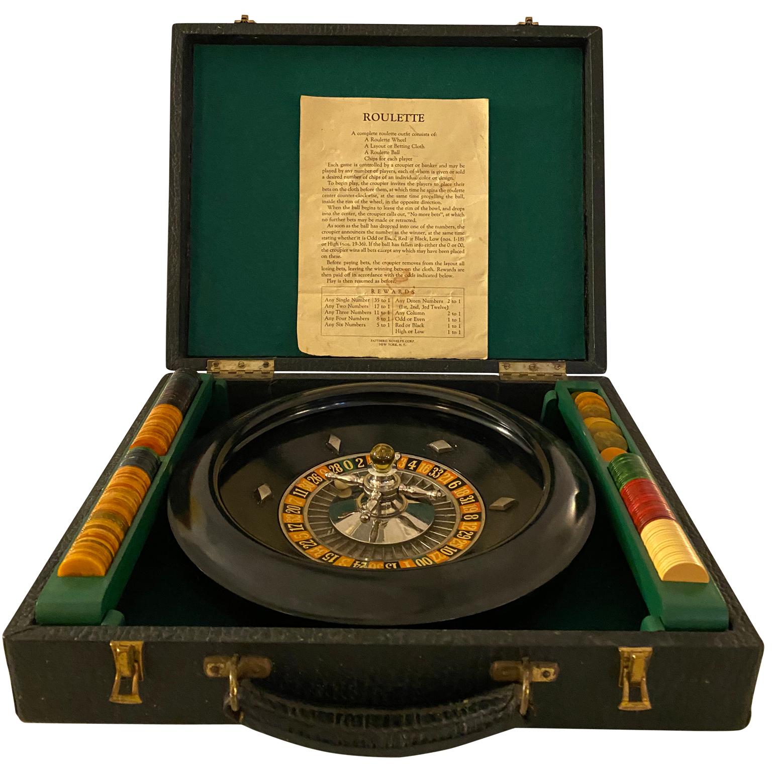 Portable bakelite roulette game set in leather case. The set is complete with green croupier viser, original marble and game pieces, bakelite betting pieces, as well as the original rules list. Carrying case is made of leather and has brass locks.