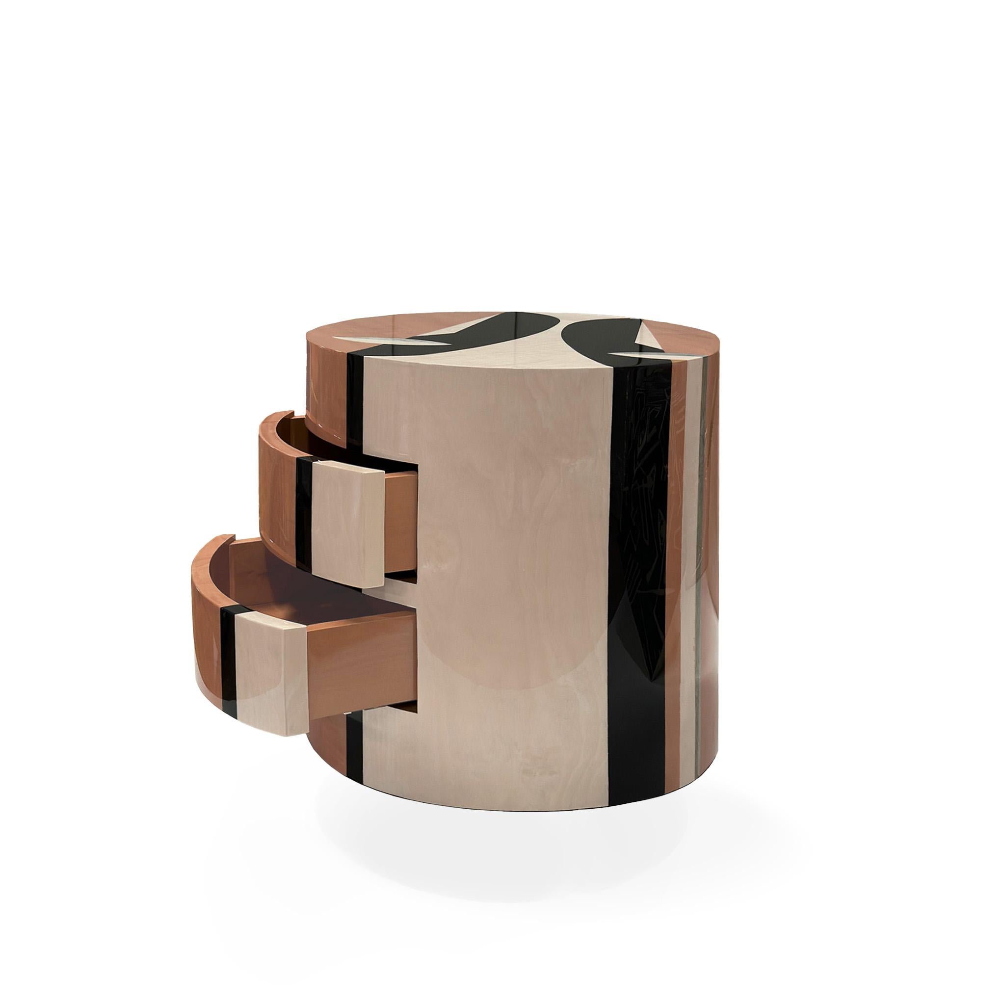 Naif Bedside Table is a modern marquetry piece for contemporary interior design projects. Eclectic and chic, this round bedside table with three drawers boasts a unique concept that will capture the attention of any bedroom decor.
The marquetry wood
