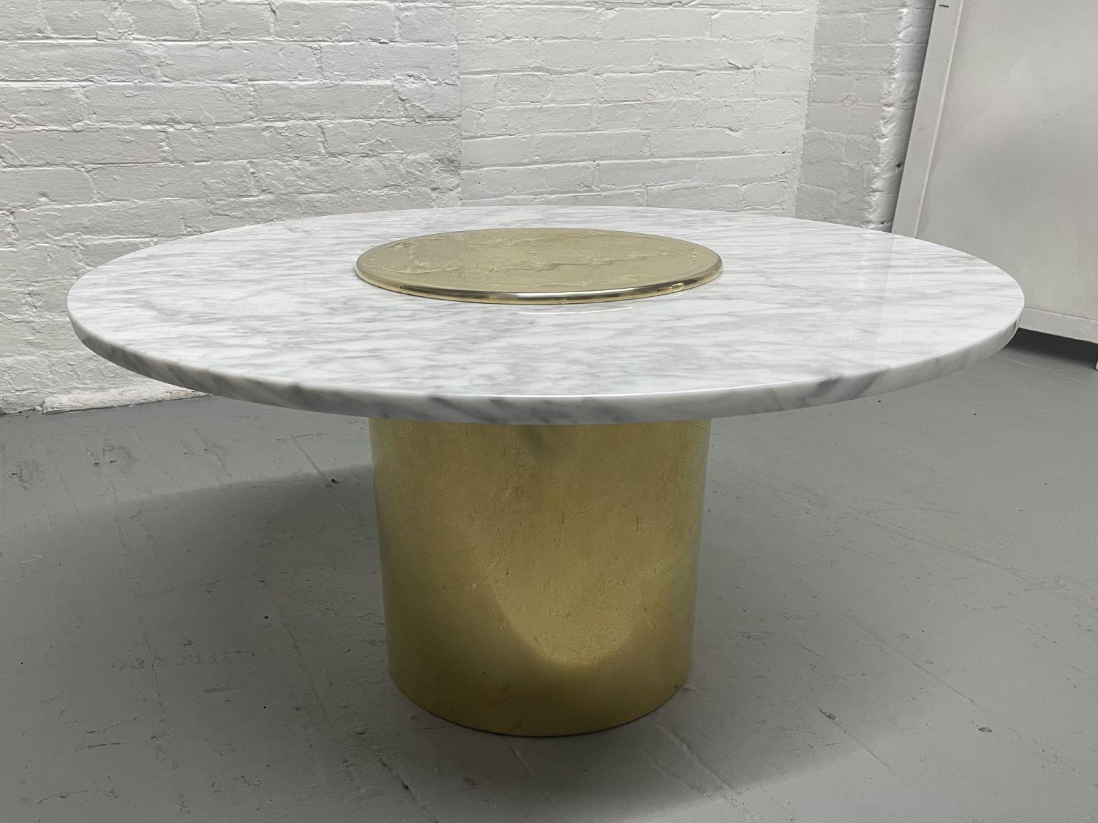 Mid-Century Modern round Carrara marble top side table. The table has a brass-plated base.