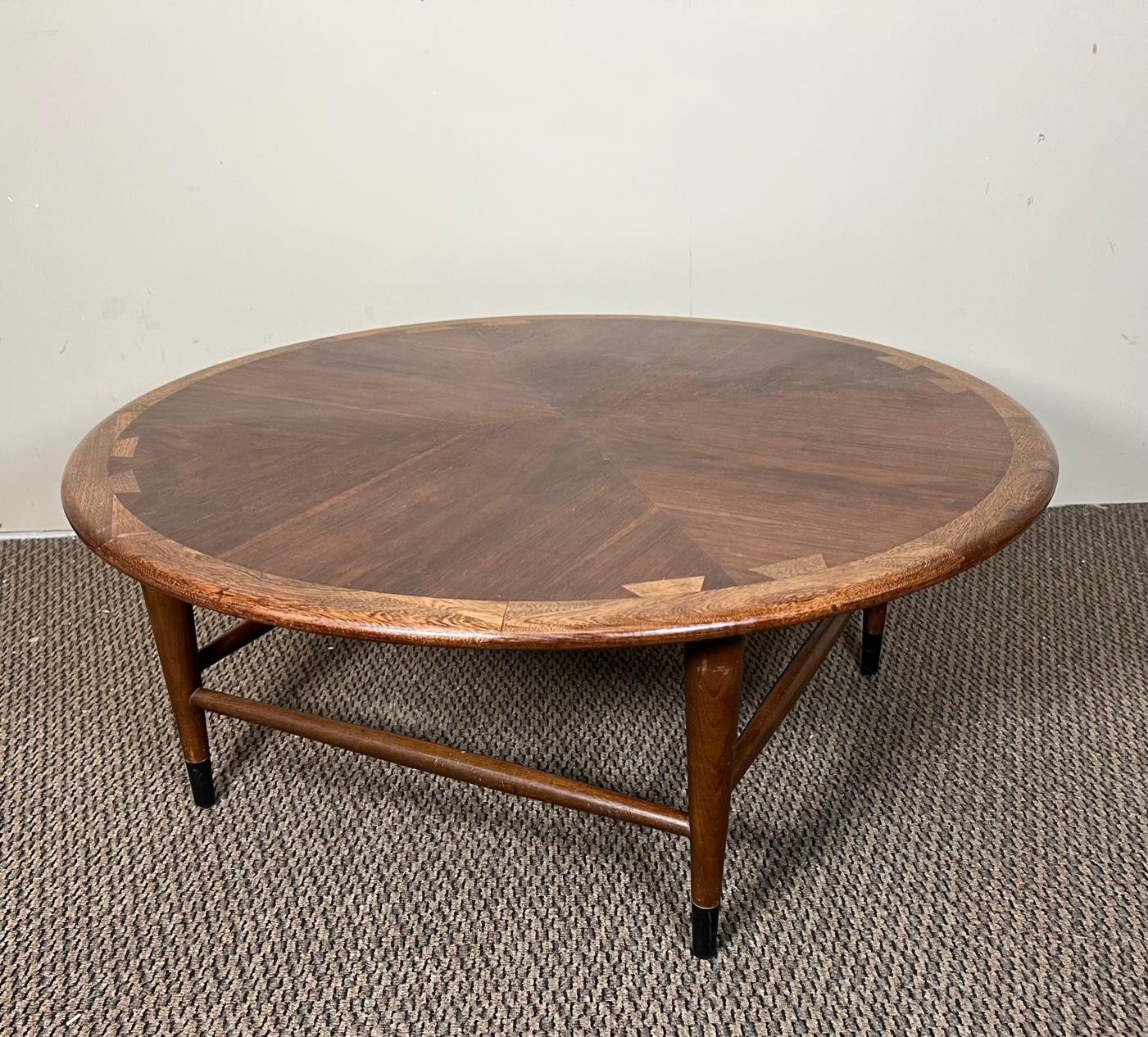 Stunning mid-century modern round dove tail coffee table by Lane Acclaim. Stamped underneath. 

Very nice condition overall. Unrefinished orginal condition. Some marks on the top. Some gouges on the sides.

Dimensions: 36