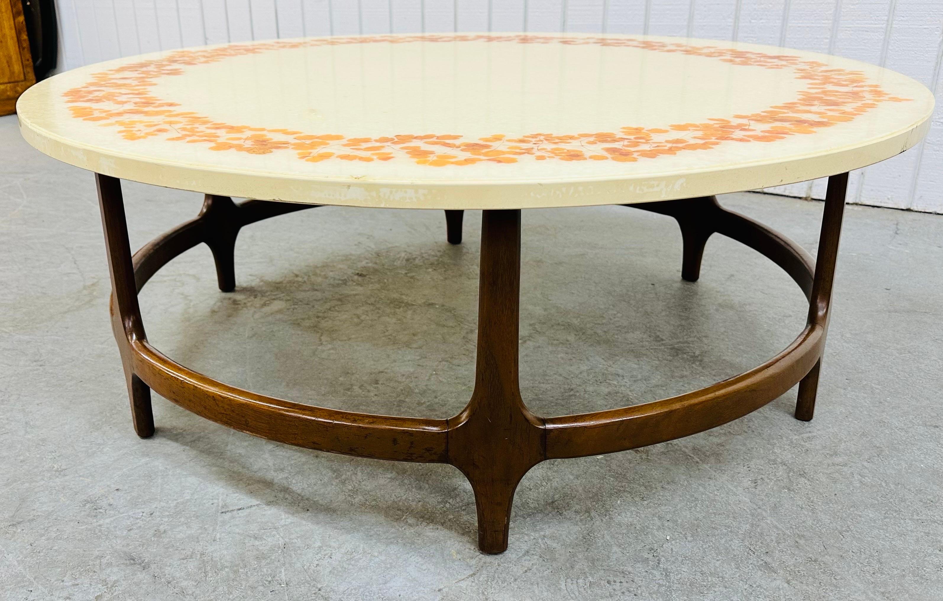 This listing is for a Mid-Century Modern Round Decorative Walnut Coffee Table. Featuring a round top with decorative sparkled leaves, sculpted wood base, with a beautiful walnut finish. This is an exceptional combination of quality and design!