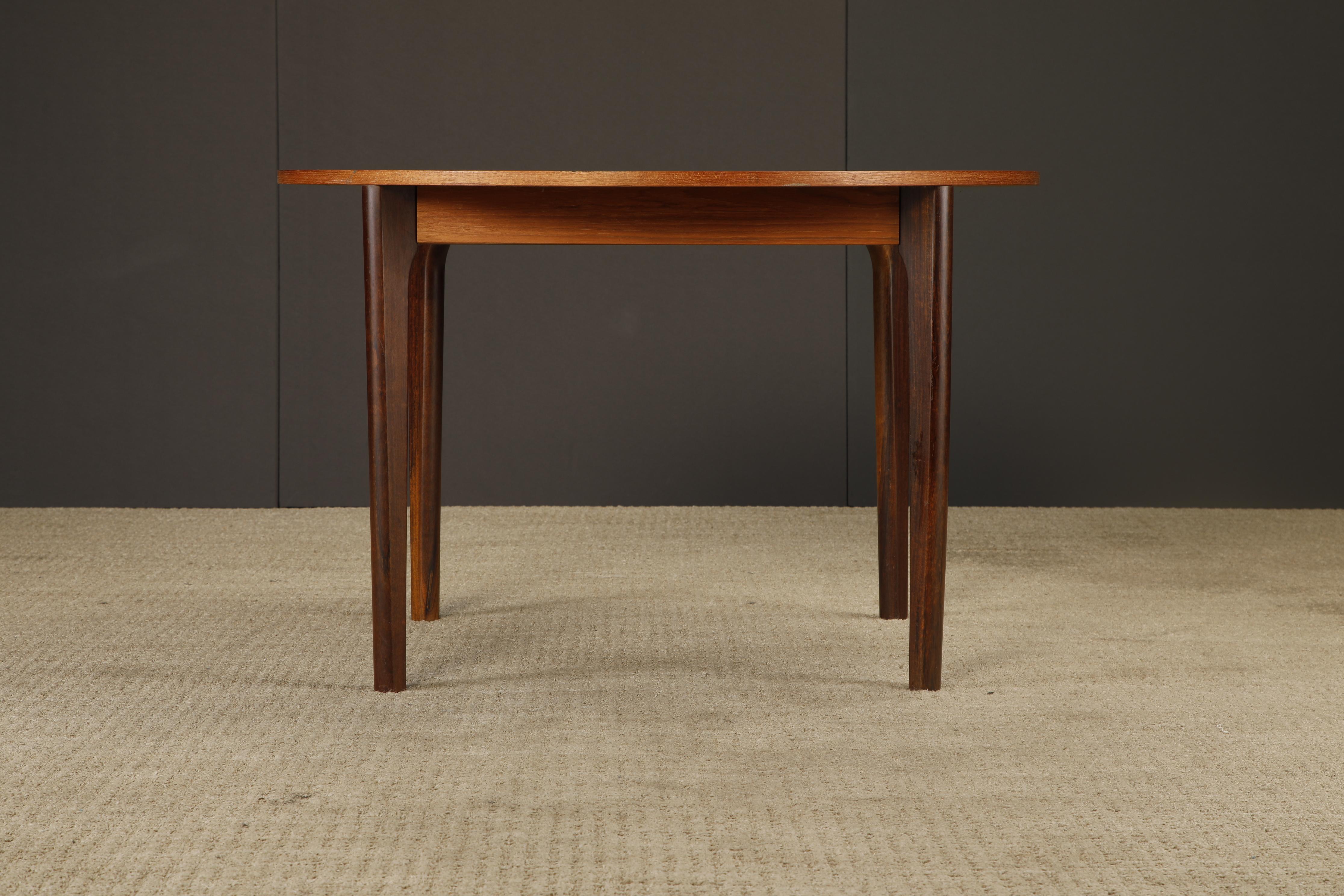 A handsome Mid-Century Modern round dining, café, or game table, crafted presumably in Denmark during the 1960s. The design is understated yet refined, featuring a warm teak top paired with contrasting darker wood legs. The combination of woods