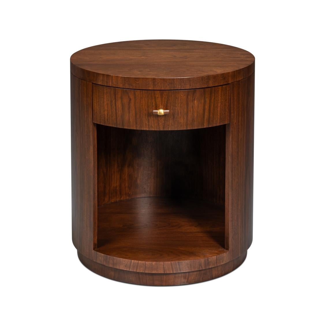 Crafted in a warm walnut finish, this piece features a refined circular profile that emphasizes symmetry and clean lines. The brass hardware detail adds a subtle touch of elegance, highlighting its mid-century inspiration.

Thoughtfully designed