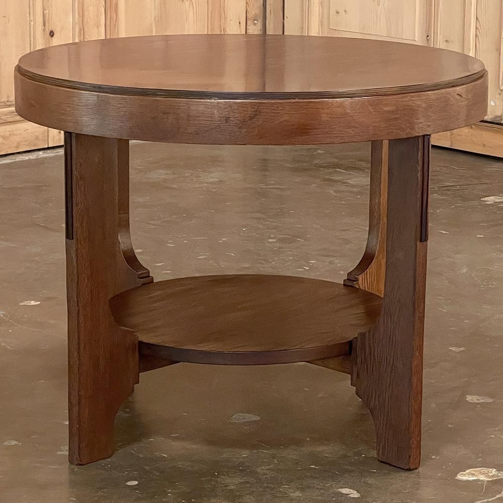 Mid-Century Modern round end table is perfect for today's casual yet stylish decors! Beautifully grained exotic hardwood veneer top has been combined with an oaken frame and a tailored two-tier design for a sublime effect. Four solid planks support