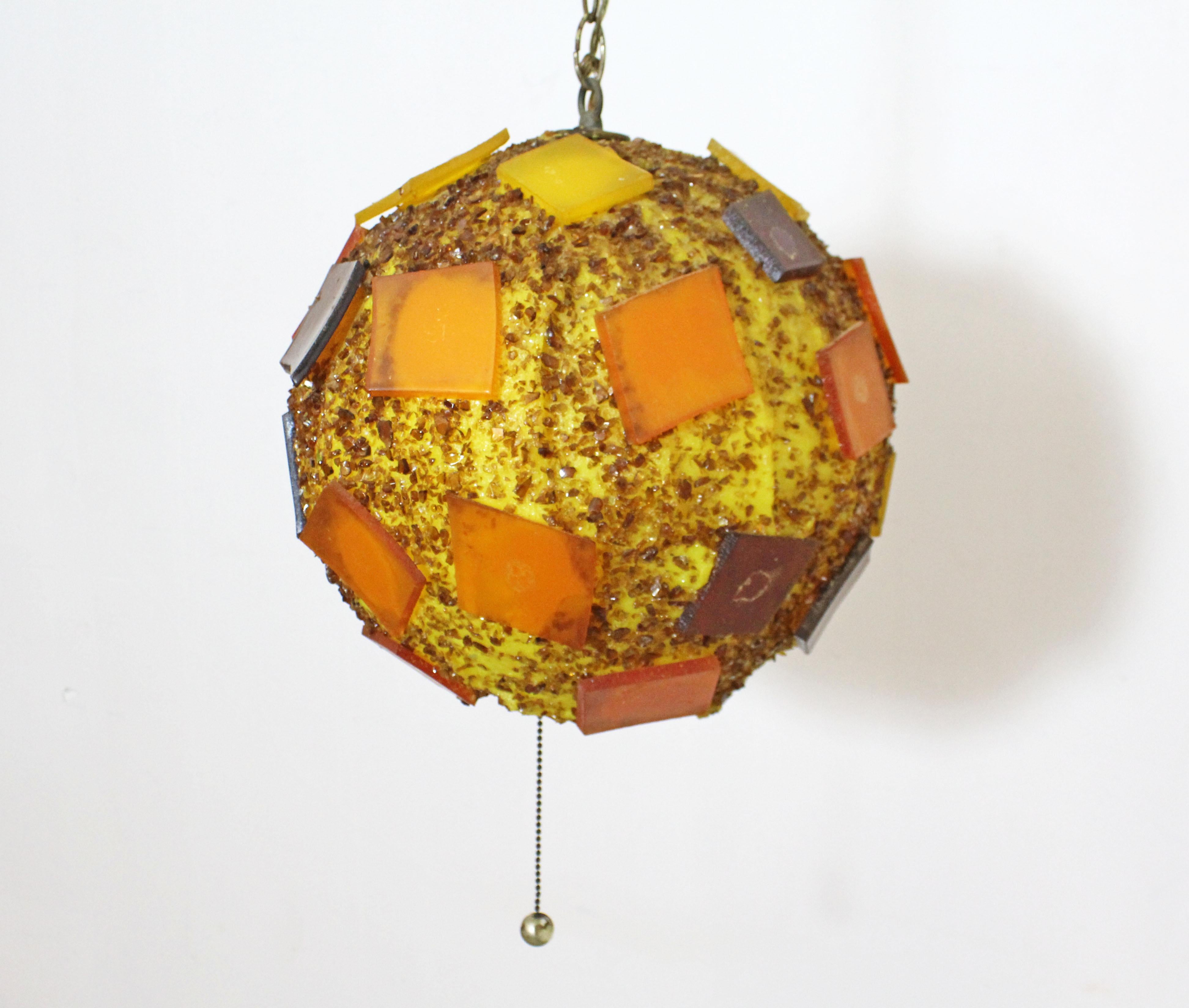 Offered is a one-of-a-kind round retro pendant lamp made with pieces of resin with a long chain. It is in excellent working condition for its age. Has some surface/age wear on resin and metal. Light has been tested. Really cool lighting for any